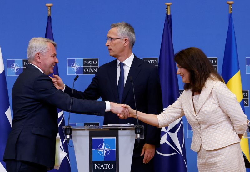 Sweden's Foreign Minister Ann Linde and Finland's Foreign Minister Pekka Haavisto shake hands during a news conference with NATO Secretary General Jens Stoltenberg, after signing their countries' accession protocols at the alliance's headquarters in Brussels, Belgium, Tuesday.