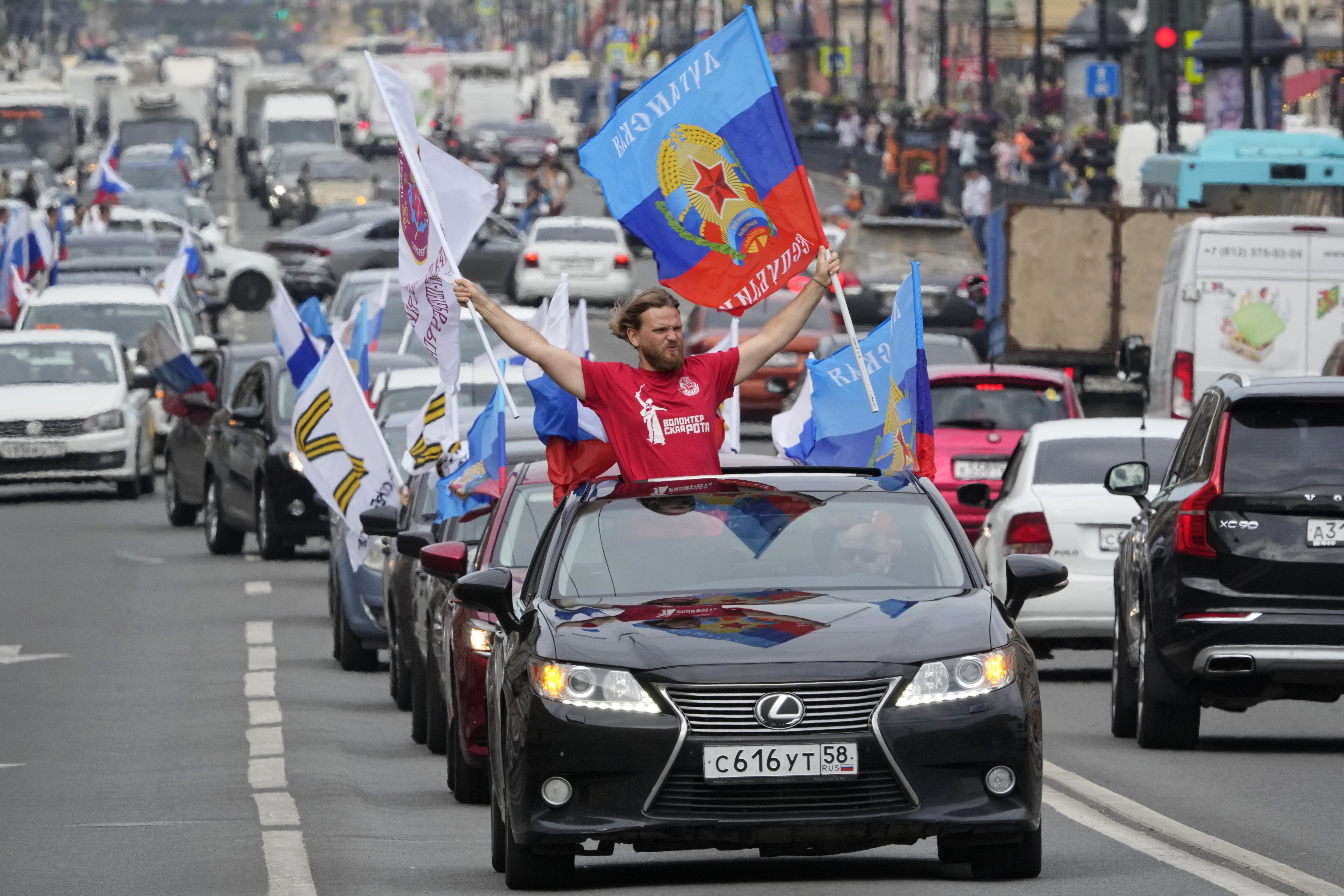 Members of a pro-Kremlin youth organization ride their cars with flags of Luhansk People Republic along the central avenue of St. Petersburg as they celebrate full control over Luhansk Region, one of the two provinces in Ukraine's eastern industrial heartland, announced by Russian authorities, in St. Petersburg, Russia, Tuesday.