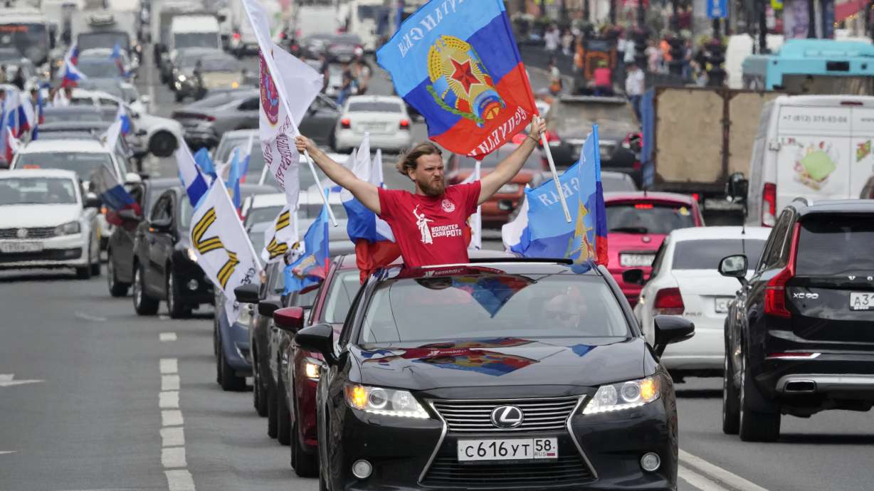 Members of a pro-Kremlin youth organization ride their cars with flags of Luhansk People Republic along the central avenue of St. Petersburg as they celebrate full control over Luhansk Region, one of the two provinces in Ukraine's eastern industrial heartland, announced by Russian authorities, in St. Petersburg, Russia, Tuesday.