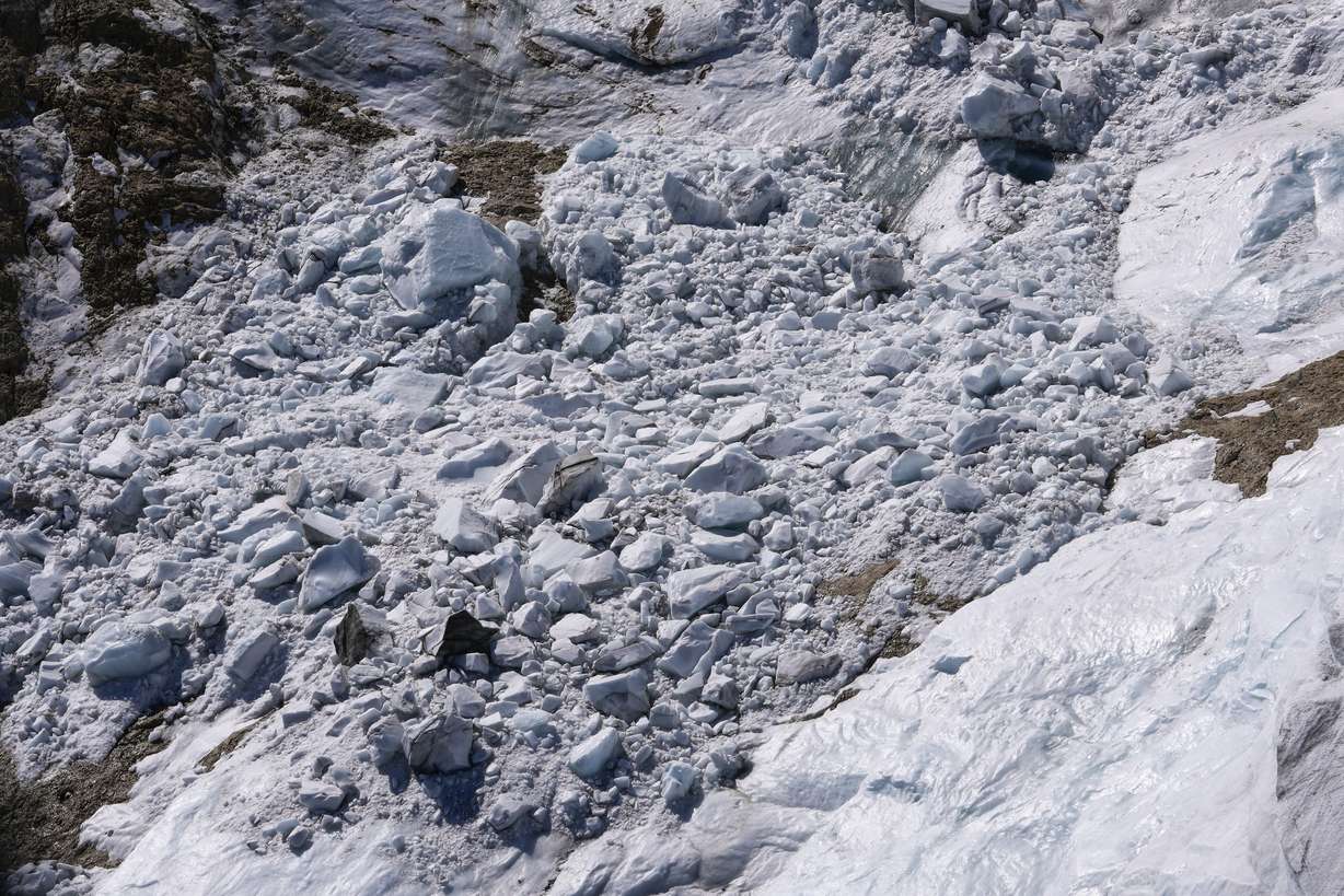 Debris and blocks of ice are seen on the Punta Rocca glacier near Canazei, in the Italian Alps in northern Italy, Tuesday, two days after a huge chunk of the glacier broke loose, sending an avalanche of ice, snow, and rocks onto hikers.