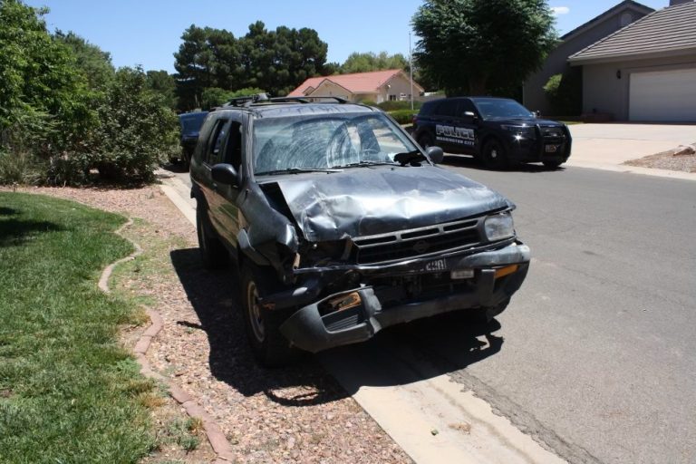 Nissan Pathfinder is heavily damaged following a crash involving two parked vehicles and bystanders in Washington City, Saturday.