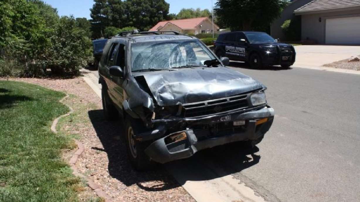 Nissan Pathfinder is heavily damaged following a crash involving two parked vehicles and bystanders in Washington City, Saturday.