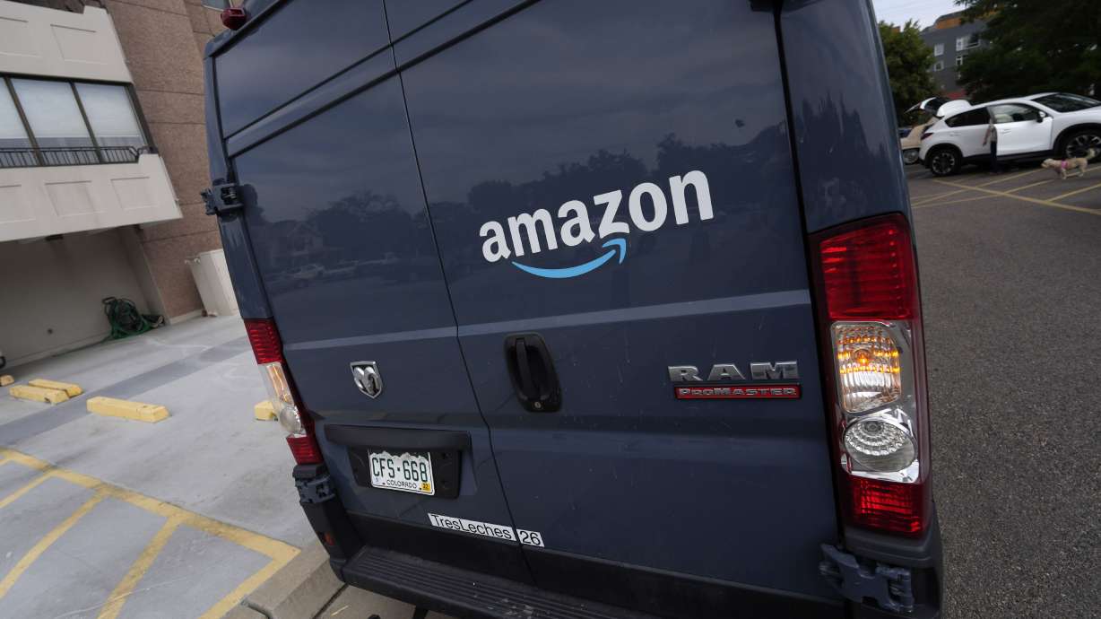 The company logo graces one of the doors of a delivery van for Amazon on Sept. 1, 2021, in Denver. Colorado has imposed a 27-cent per order retail delivery fee for deliveries by motor vehicle to consumers, no matter who owns or operates the vehicle used to make the delivery.
