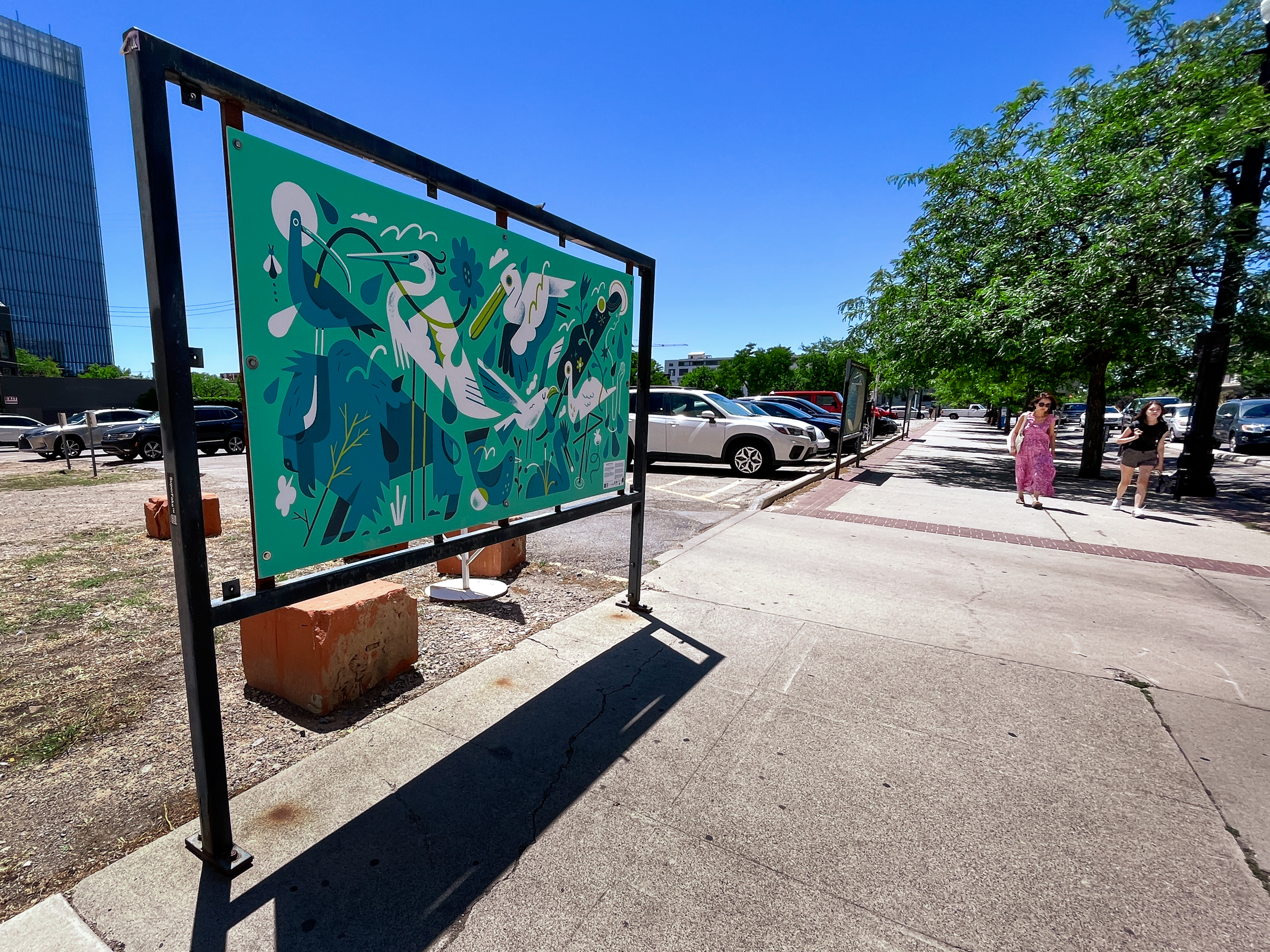 People walk by a painting from the Celebration of the Hand: Save Our Great Salt Lake on 300 South in Salt Lake City on Tuesday. The painting is one of over a dozen that highlight the issues with the drying Great Salt Lake, which reached a record low this week.