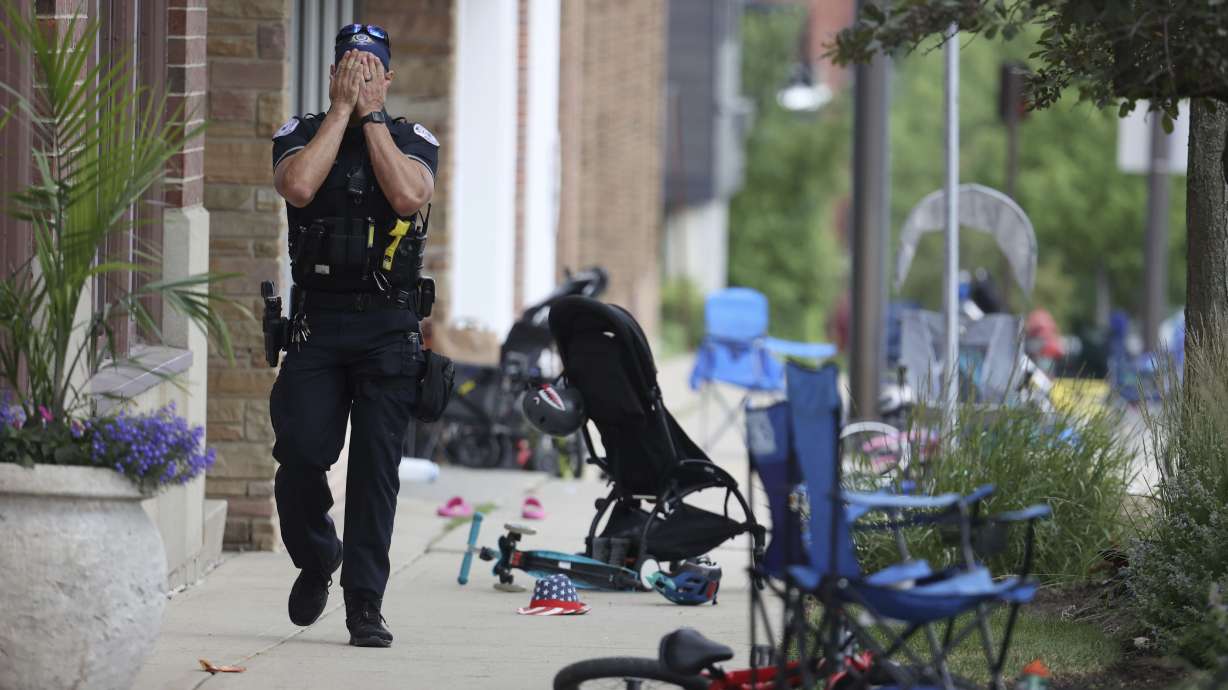 A Lake Forest, Ill., police officer walks down Central Ave in Highland Park, Ill., on Monday, after a shooter fired on the northern Chicago suburb’s Fourth of July parade. A new Deseret News/Hinckley Institute of Politics poll found that 43% of Utahns believe mental health treatment challenges are the principal cause for mass shootings.
