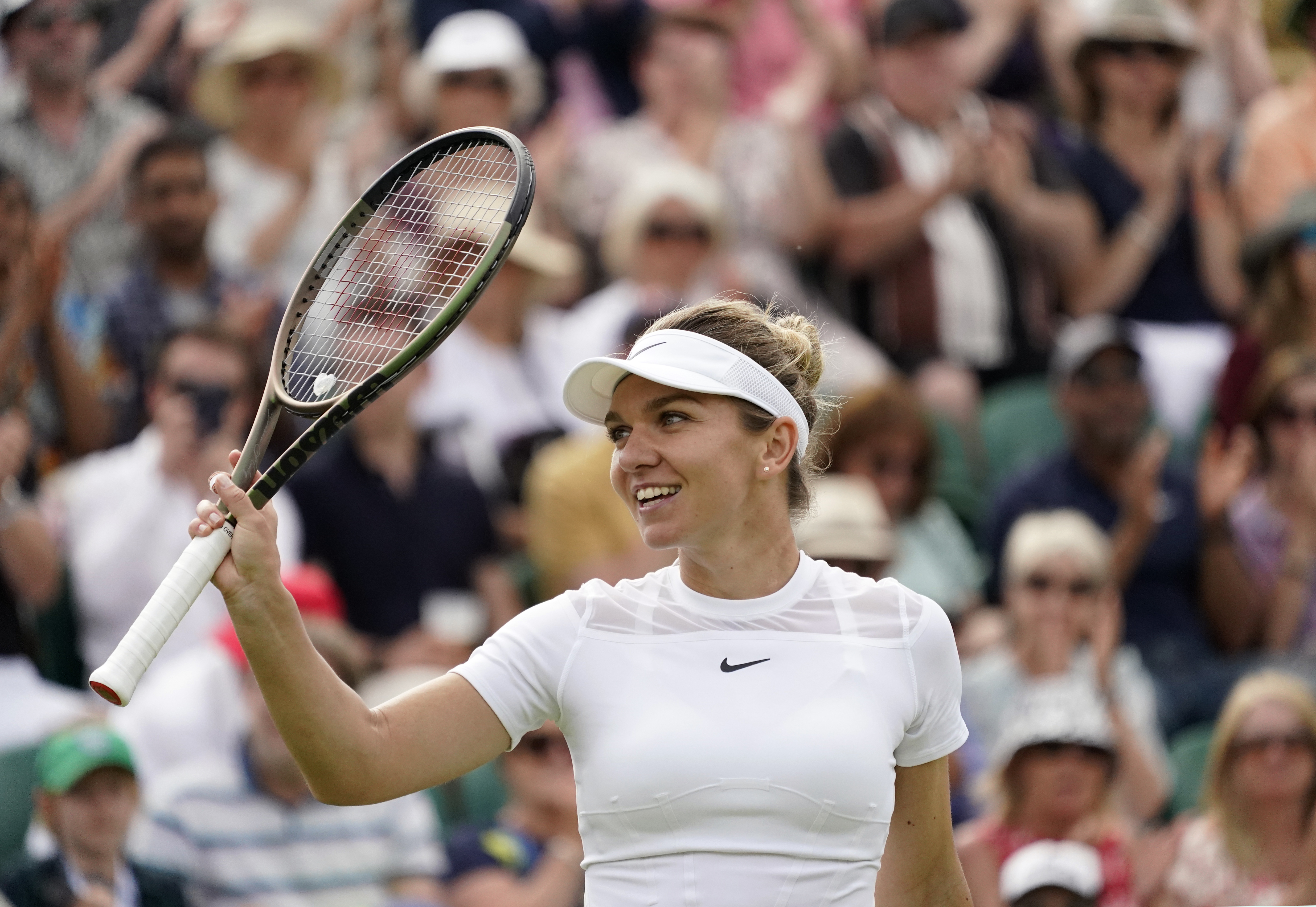 Romania's Simona Halep celebrates after beating Poland's Magdalena Frech in their women's third round singles match on day six of the Wimbledon tennis championships in London, Saturday, July 2, 2022. 
