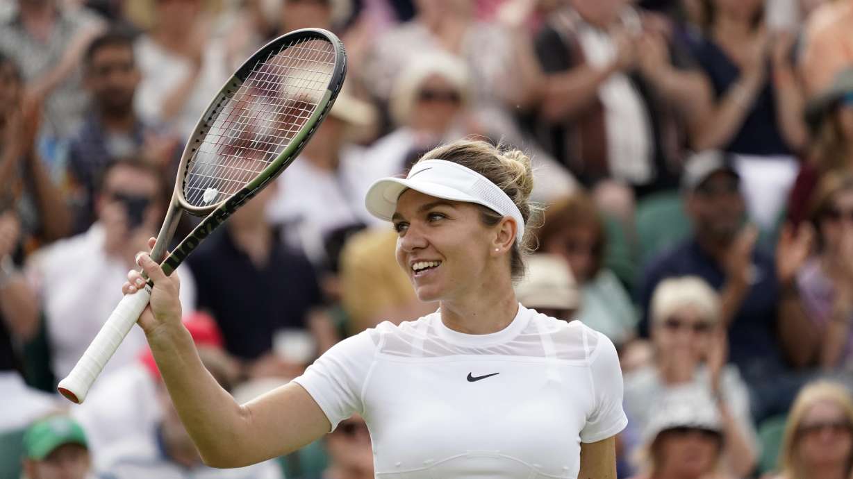Romania's Simona Halep celebrates after beating Poland's Magdalena Frech in their women's third round singles match on day six of the Wimbledon tennis championships in London, Saturday, July 2, 2022.