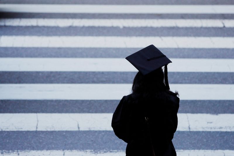 A graduating student waits to cross the street before Commencement Exercises at the Massachusetts Institute of Technology in Cambridge, Massachusetts, June 7, 2019. The U.S. government wants to simplify the student loan forgiveness process for defrauded students and make it easier for public servants to get the debt forgiveness, the Education Department said on Wednesday.