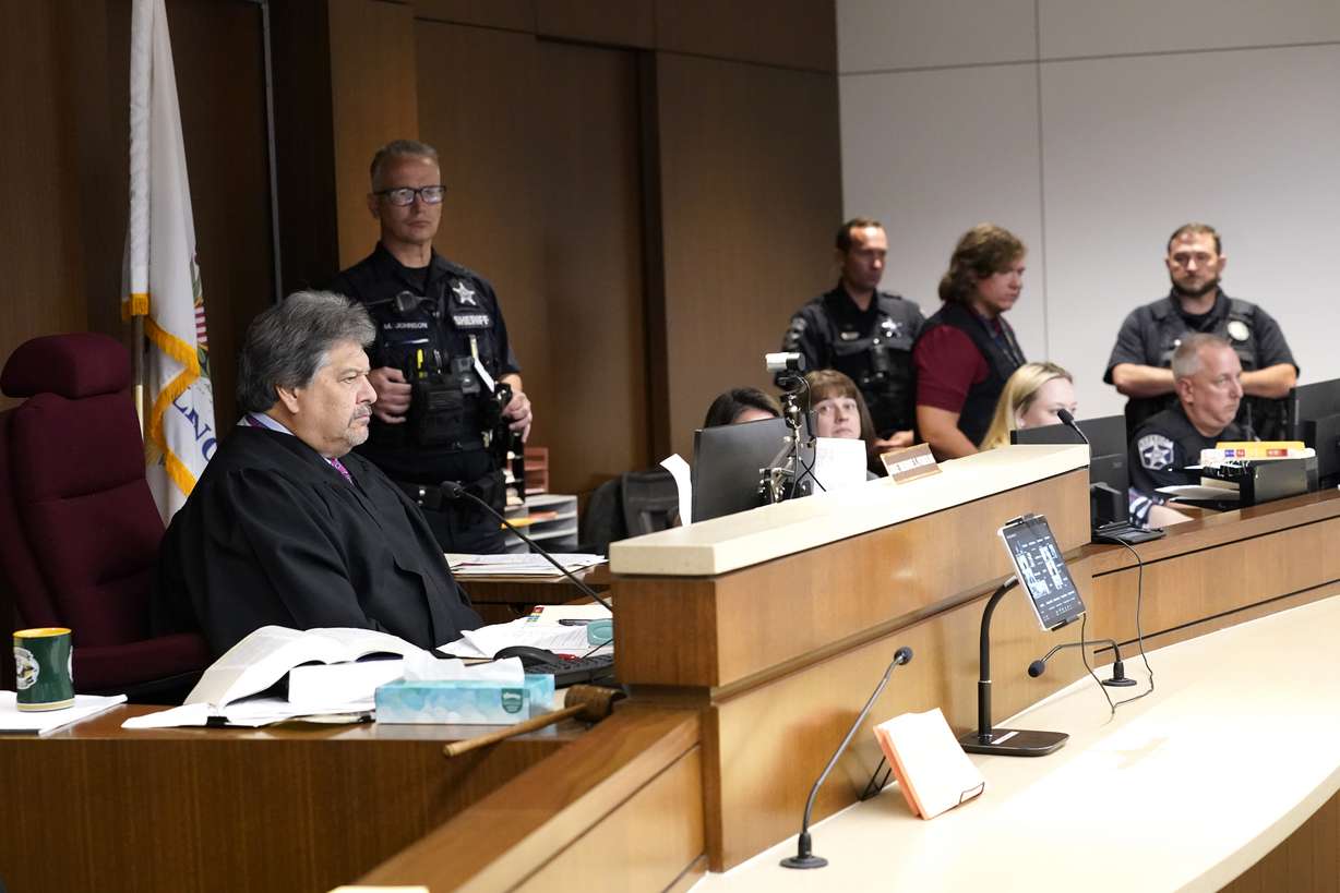Lake County Judge Theodore Potkonjak, left, looks at a video screen as he presides over the initial appearance of Robert E. Crimo III at the county courthouse Wednesday, in Waukegan, Ill.
