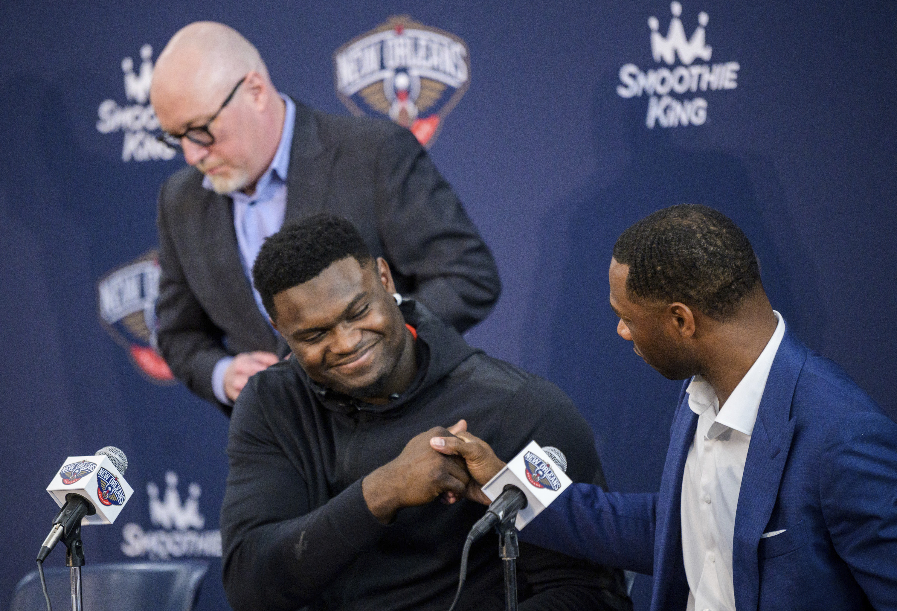 New Orleans Pelicans forward Zion Williamson shakes hands with New Orleans Pelicans head coach Willie Green with New Orleans Pelicans vice president of basketball operations David Griffin standing in the background after talking to the media about signing his contract extension at the Dryades YMCA in New Orleans, Wednesday, July 6, 2022. 