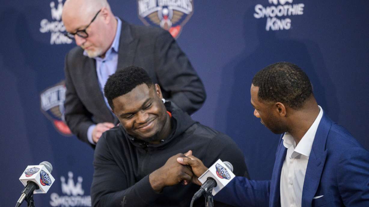 New Orleans Pelicans forward Zion Williamson shakes hands with New Orleans Pelicans head coach Willie Green with New Orleans Pelicans vice president of basketball operations David Griffin standing in the background after talking to the media about signing his contract extension at the Dryades YMCA in New Orleans, Wednesday, July 6, 2022.