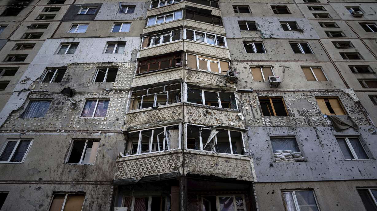 An apartment building damaged by a Russian attack in Saltivka district in Kharkiv, Ukraine, Tuesday. As Russia's invasion of Ukraine grinds into its fifth month, some residents close to the front lines remain in shattered and nearly abandoned neighborhoods.