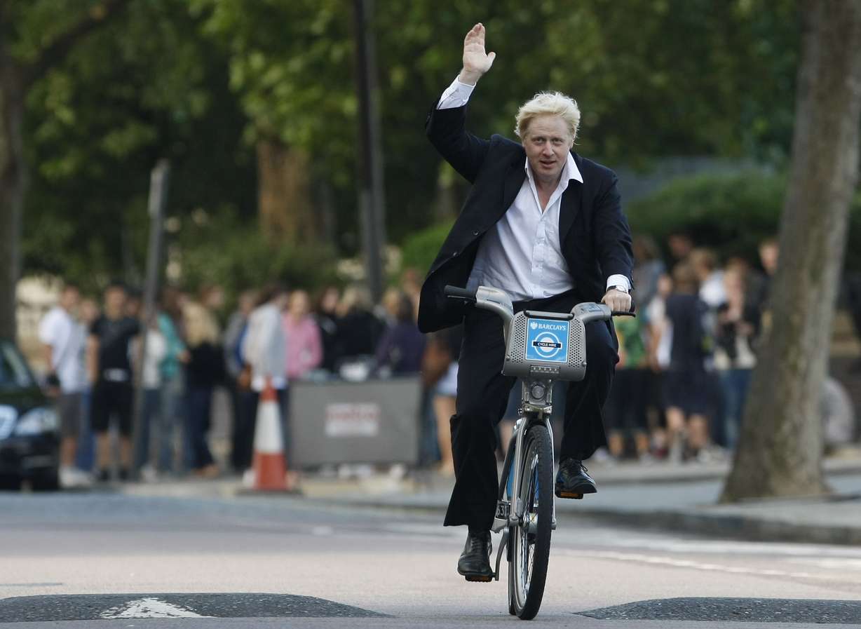 Boris Johnson, Mayor of London waves to the media as he helps launch a new cycle hire scheme in London, July 30, 2010.