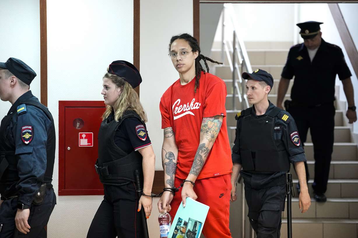 WNBA star and two-time Olympic gold medalist Brittney Griner is escorted to a courtroom for a hearing, in Khimki just outside Moscow, Russia, Thursday.