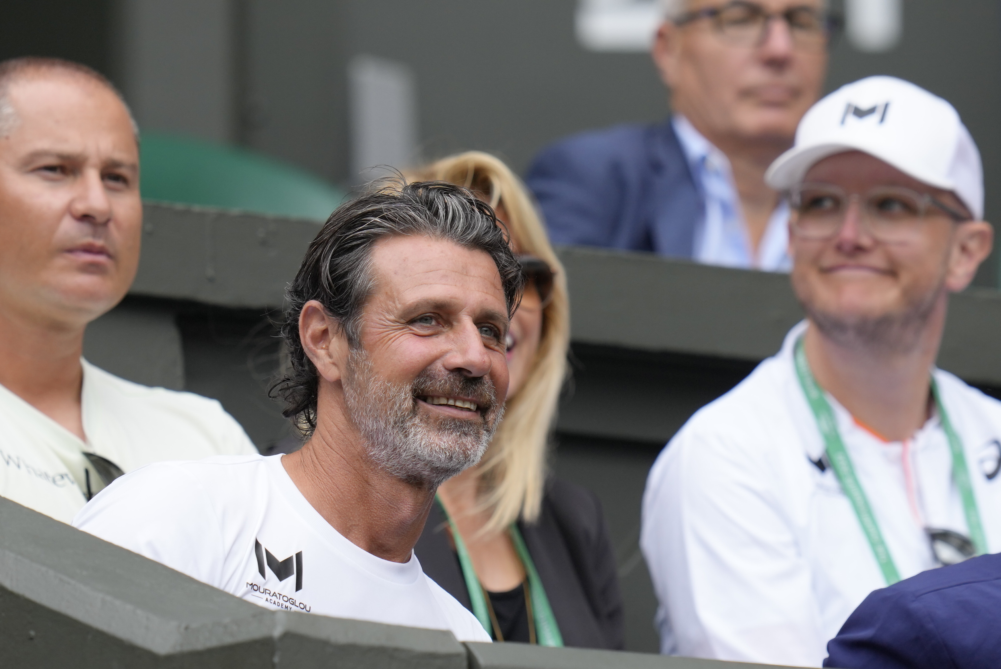 Patrick Mouratoglou, the coach of Romania's Simona Halep sits in the players box for her match against Amanda Anisimova of the US in the women's singles quarterfinals on day ten of the Wimbledon tennis championships in London, Wednesday, July 6, 2022. 