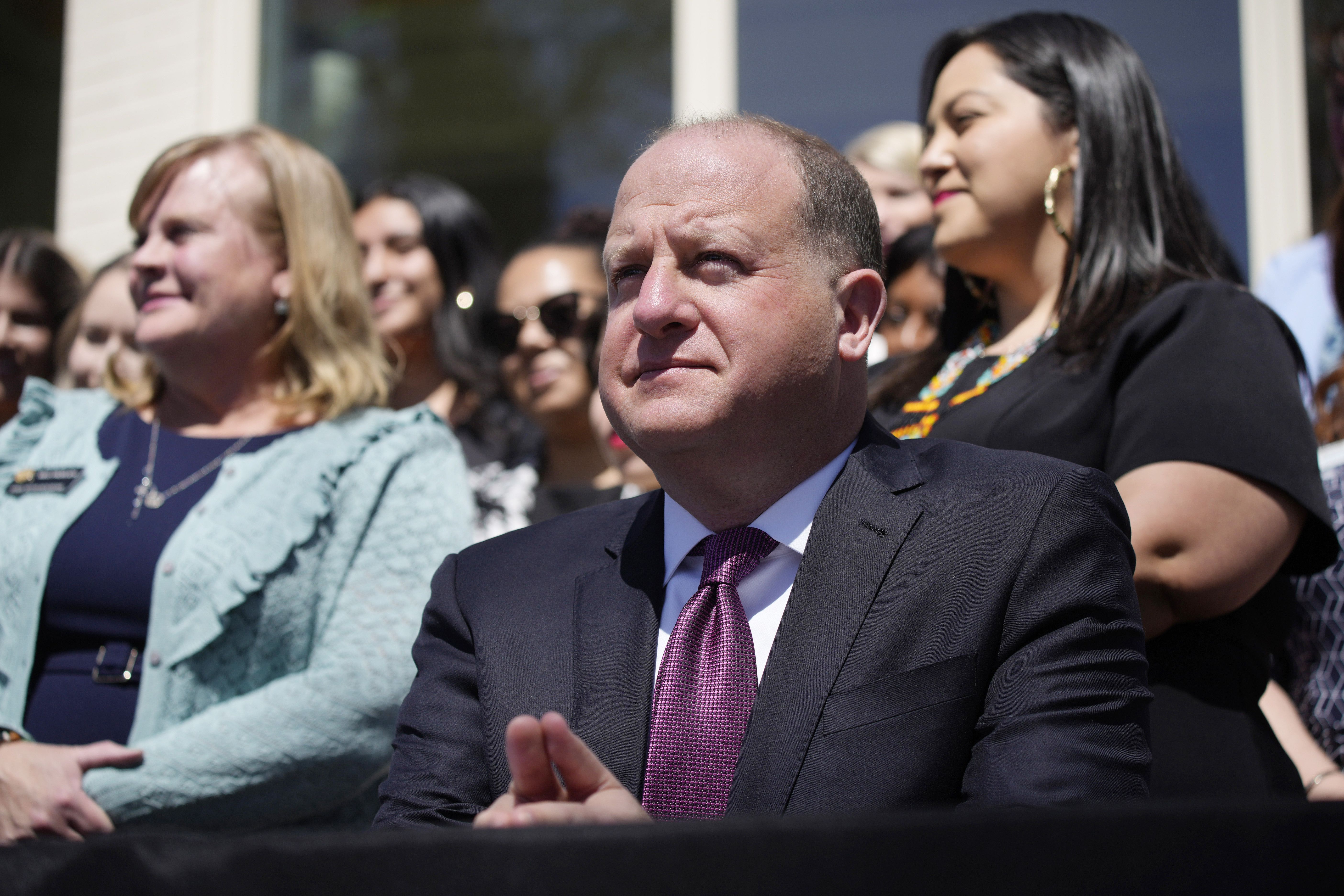 Colorado Gov. Jared Polis waits to sign into law the reproductive health equity act during a ceremony outside of the governor’s mansion in Denver on April 4. Polis on Wednesday, signed an executive order to strengthen the state’s abortion rights and provide additional protections for those traveling to the state seeking abortion care.