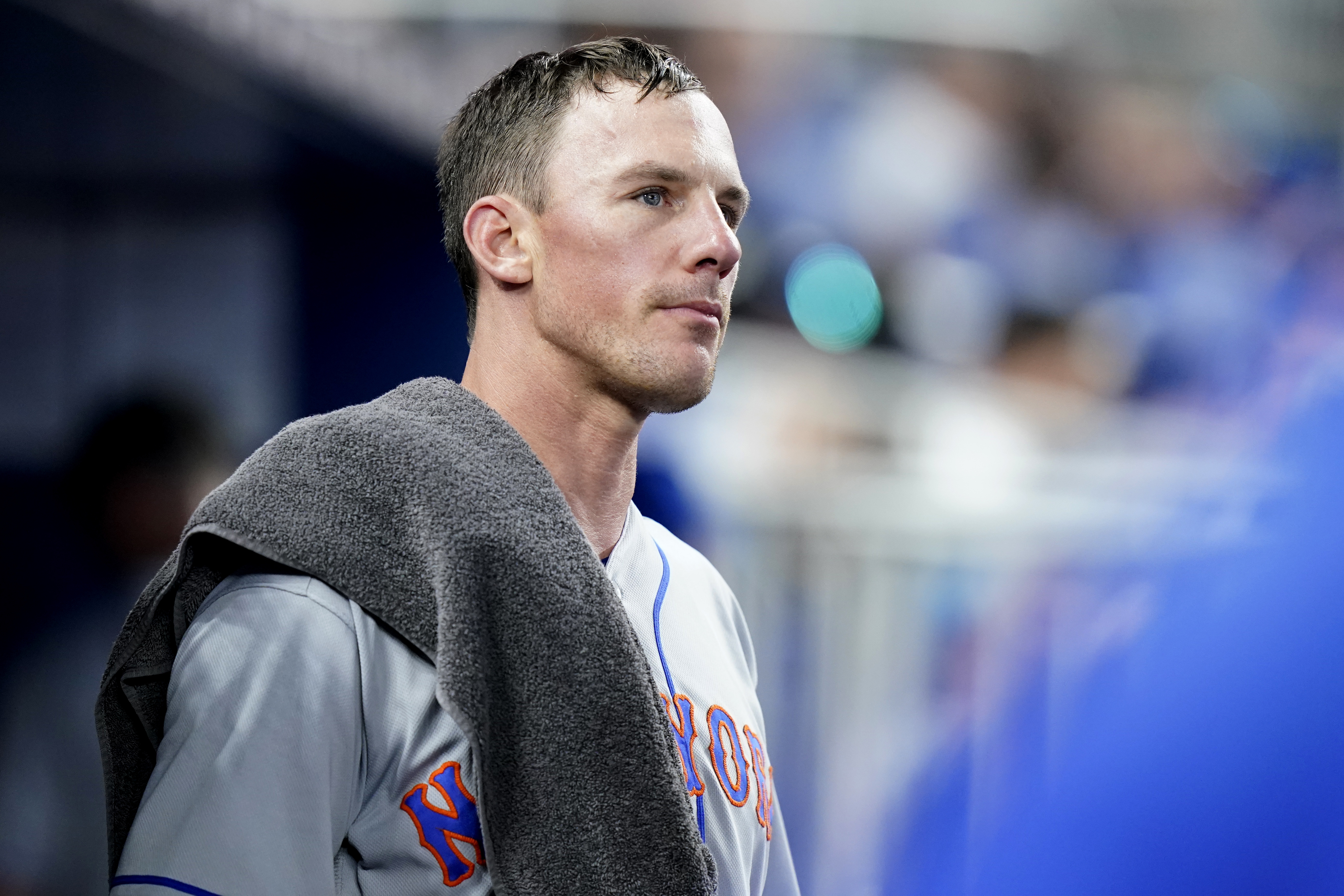 New York Mets starting pitcher Chris Bassitt looks out from the dugout after pitching in the fourth inning of a baseball game against the Miami Marlins, Saturday, June 25, 2022, in Miami. The Marlins scored two runs in the inning. 