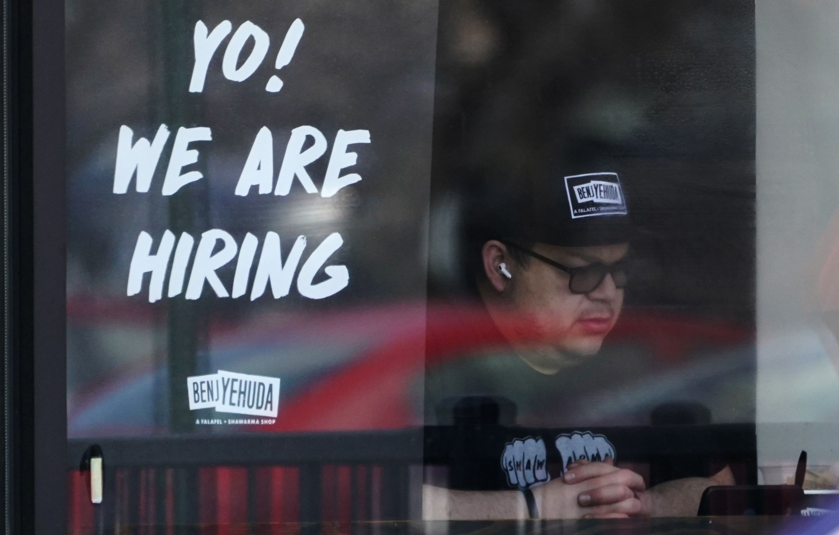 A hiring sign is displayed at a restaurant in Schaumburg, Ill., April 1. America's employers shrugged off high inflation to add 372,000 jobs in June, the Labor Department reported Friday.
