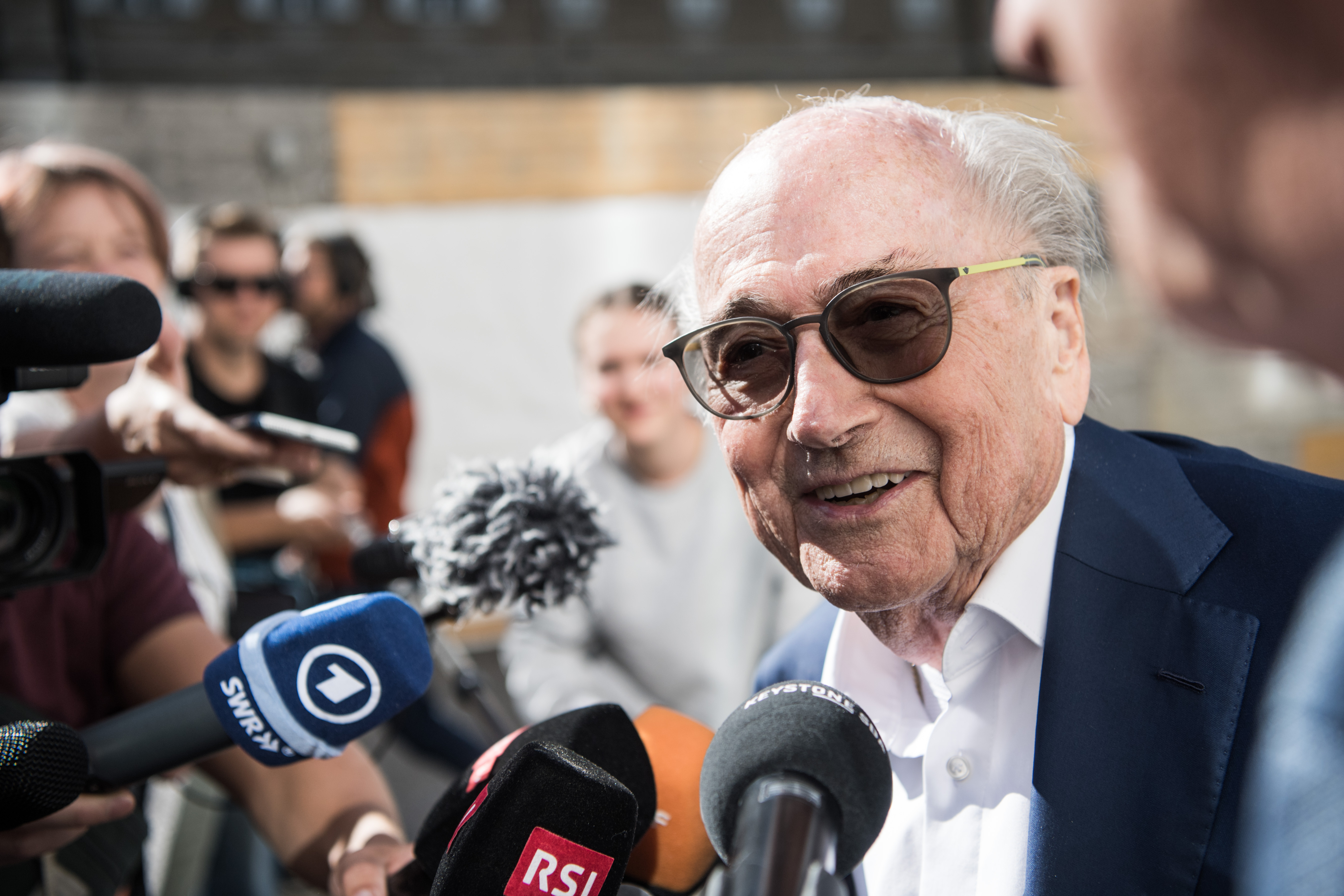 The former president of the World Football Association (Fifa), Joseph Blatter, surrounded by media representatives, gives statements in front of the Swiss Federal Criminal Court in Bellinzona, Switzerland, before the last day of the trail, when the verdict is to be announced, Friday, July 8, 2022. Blatter and the former president of the the European Football Association (Uefa), Michel Platini, stand trial before the Federal Criminal Court from Wednesday, over a suspicious two-million payment. The Federal Prosecutor's Office accuses them of fraud. The defense speaks of a conspiracy.