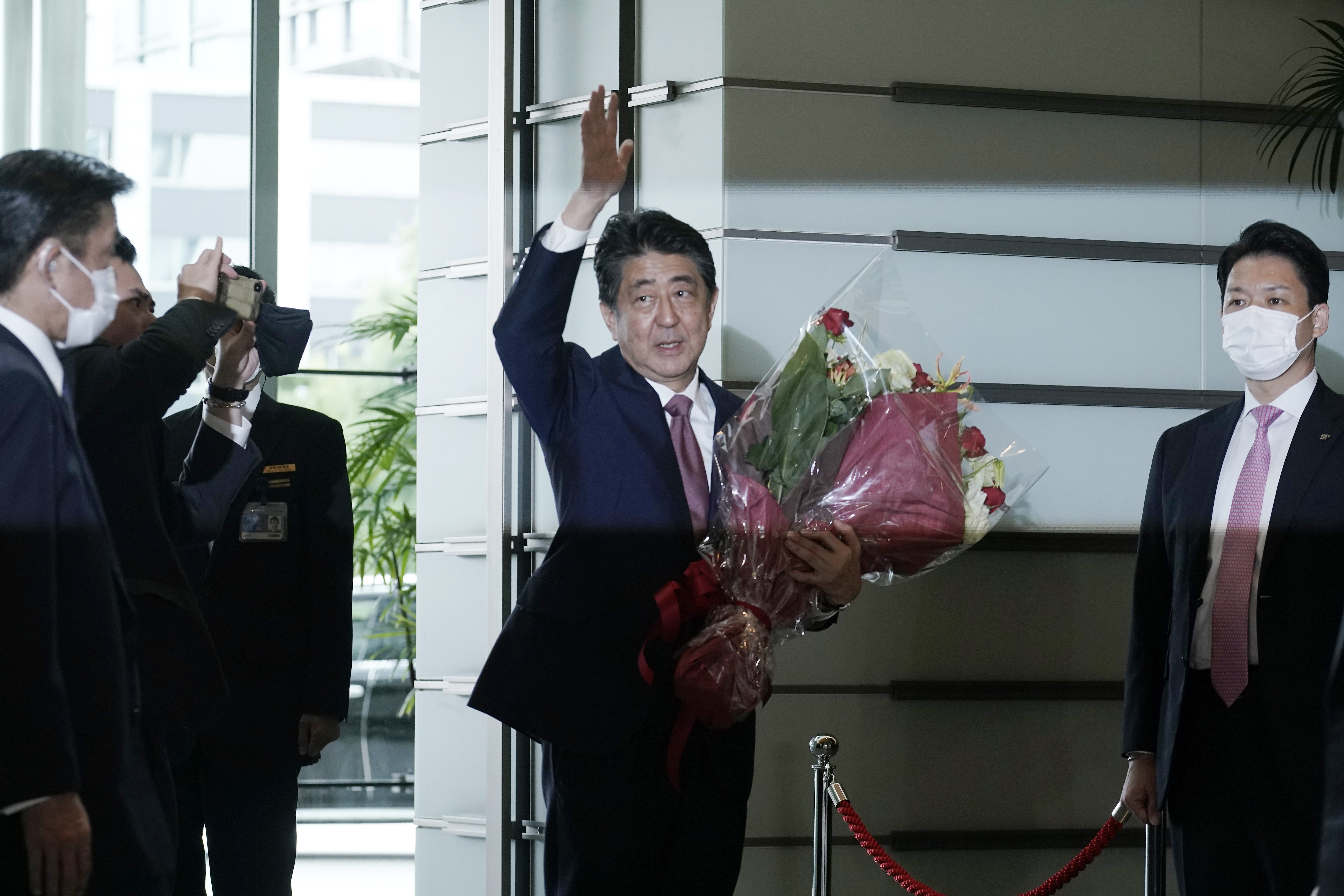 Japan's outgoing Prime Minister Shinzo Abe waves as he leaves the prime minister's office Sept. 16, 2020, in Tokyo. Utah and national leaders joined the world in mourning his assassination Friday.