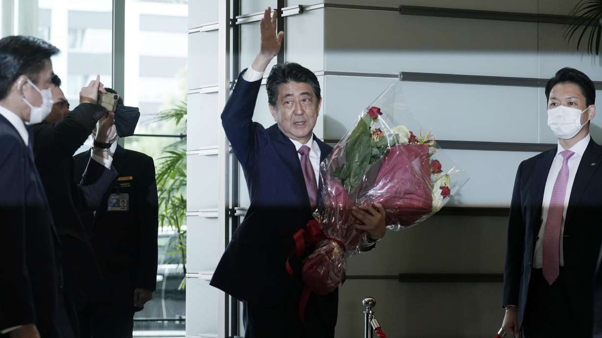 Japan's outgoing Prime Minister Shinzo Abe waves as he leaves the prime minister's office Sept. 16, 2020, in Tokyo. Utah and national leaders joined the world in mourning his assassination Friday.