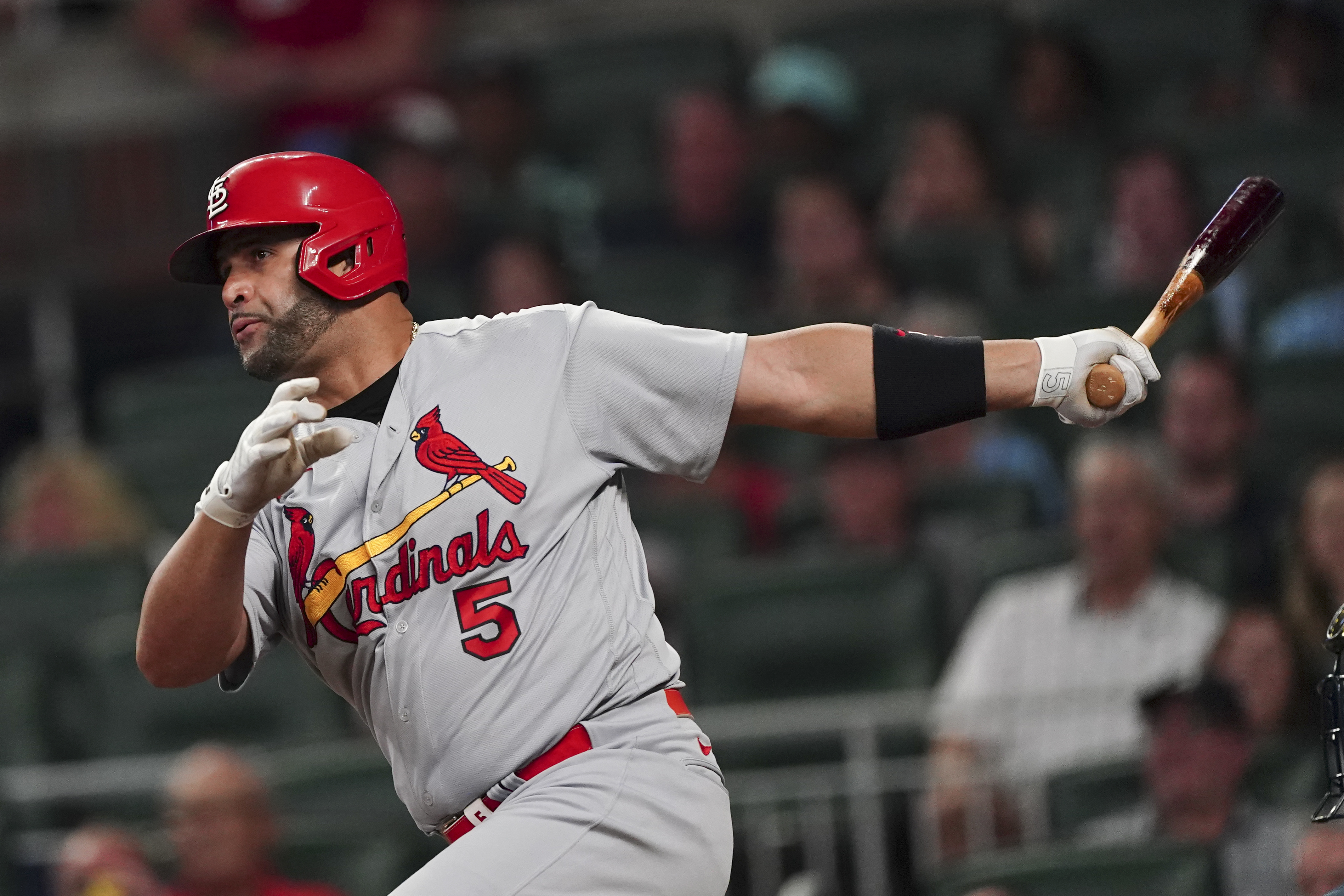St. Louis Cardinals pinch hitter Albert Pujols drives in a run with a sacrifice fly in the seventh inning of a baseball game against the Atlanta Braves, Thursday, July 7, 2022, in Atlanta. 