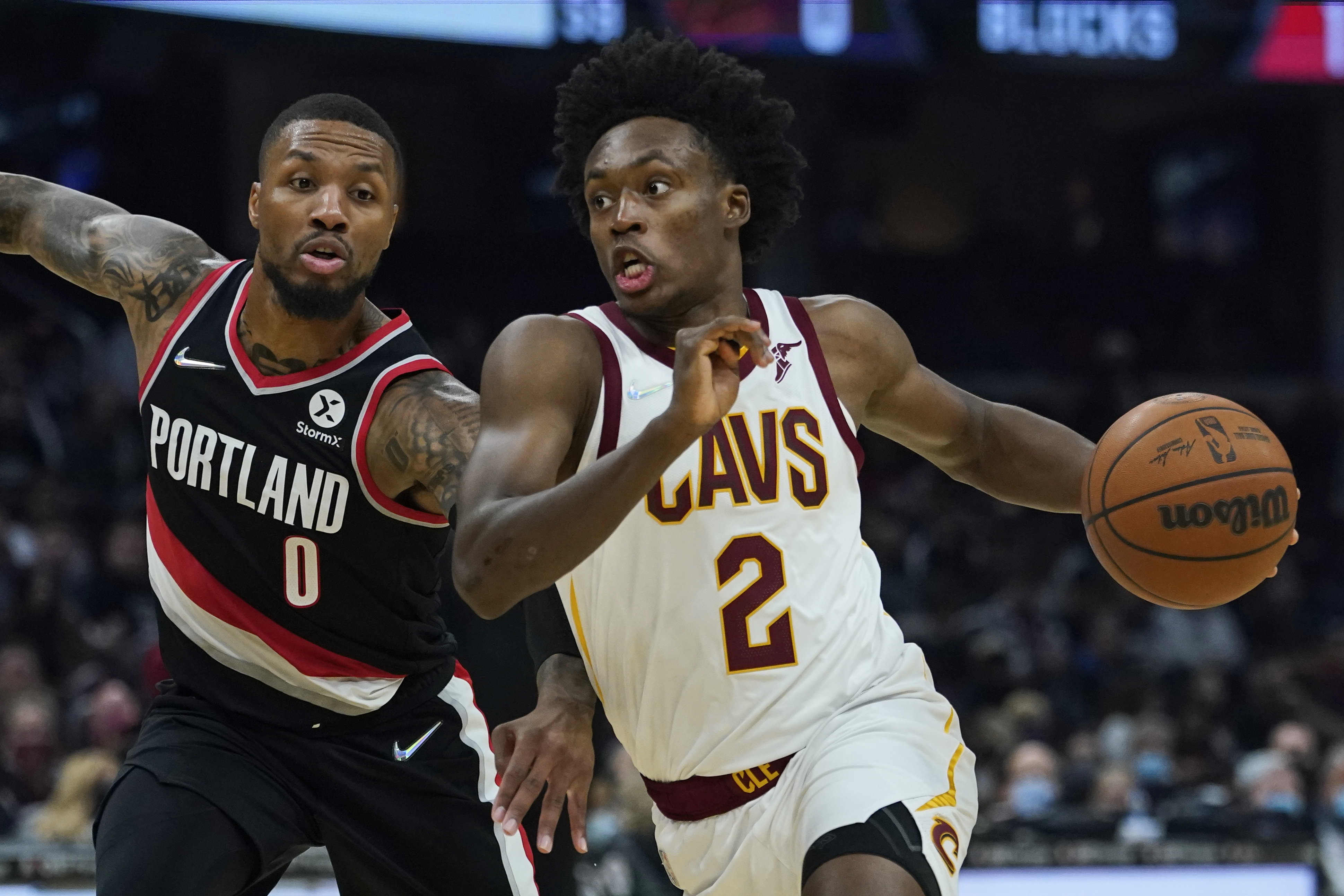 FILE - Cleveland Cavaliers' Collin Sexton (2) drives against Portland Trail Blazers' Damian Lillard (0) in the first half of an NBA basketball game, Wednesday, Nov. 3, 2021, in Cleveland. The Cavaliers made the expected move Tuesday, June 28, 2022, and extended a qualifying offer to guard Collin Sexton, who missed most of last season with a knee injury.