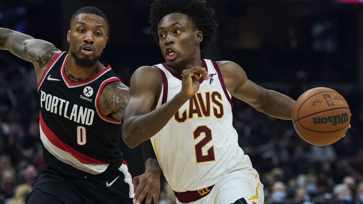 FILE - Cleveland Cavaliers' Collin Sexton (2) drives against Portland Trail Blazers' Damian Lillard (0) in the first half of an NBA basketball game, Wednesday, Nov. 3, 2021, in Cleveland. The Cavaliers made the expected move Tuesday, June 28, 2022, and extended a qualifying offer to guard Collin Sexton, who missed most of last season with a knee injury.