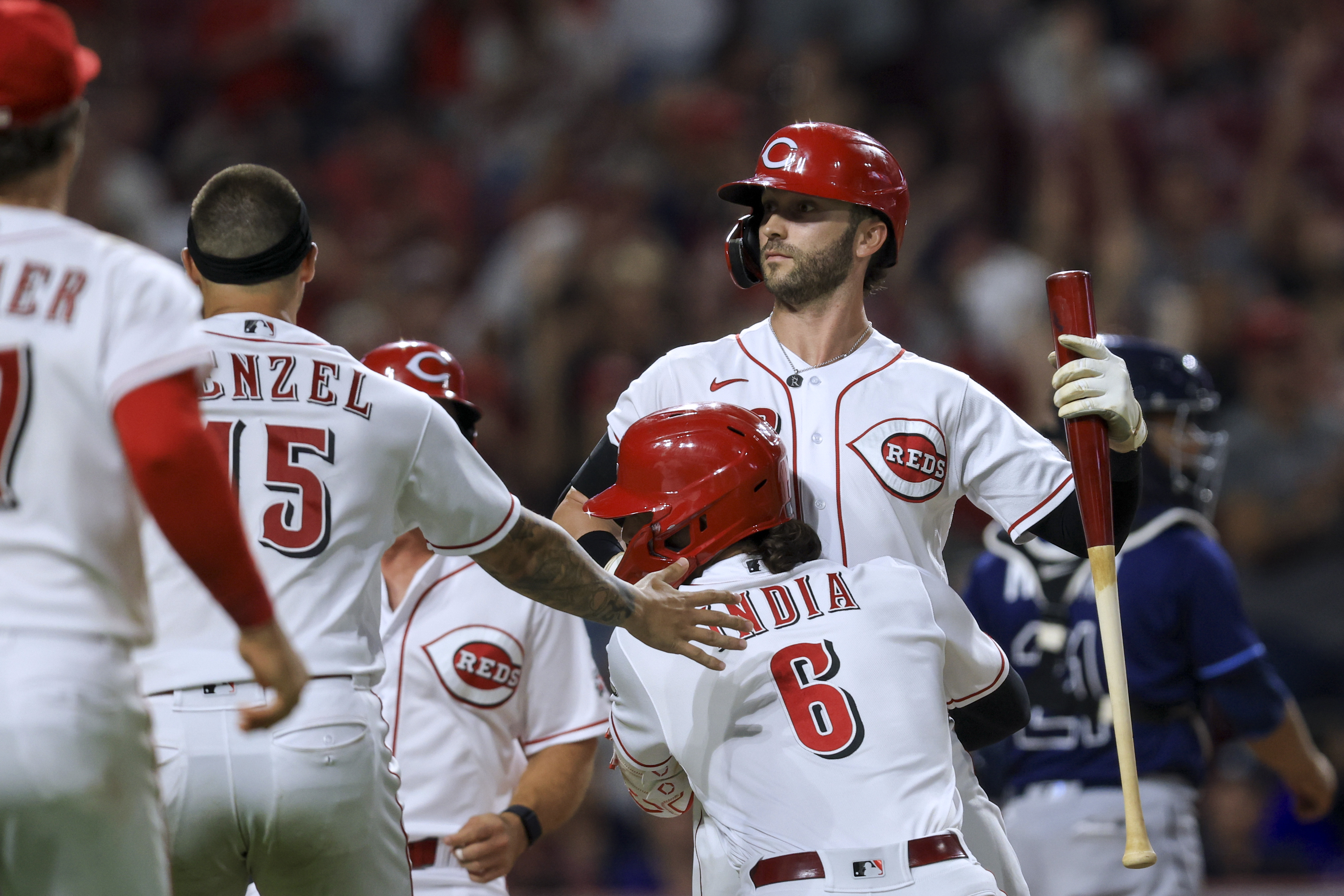 Cincinnati Reds' Tyler Naquin celebrates with teammates, including Jonathan India, after a balk by Tampa Bay Rays' Jason Adam scored the winning run during the 10th inning of a baseball game in Cincinnati, Friday, July 8, 2022. The Reds won 2-1. 