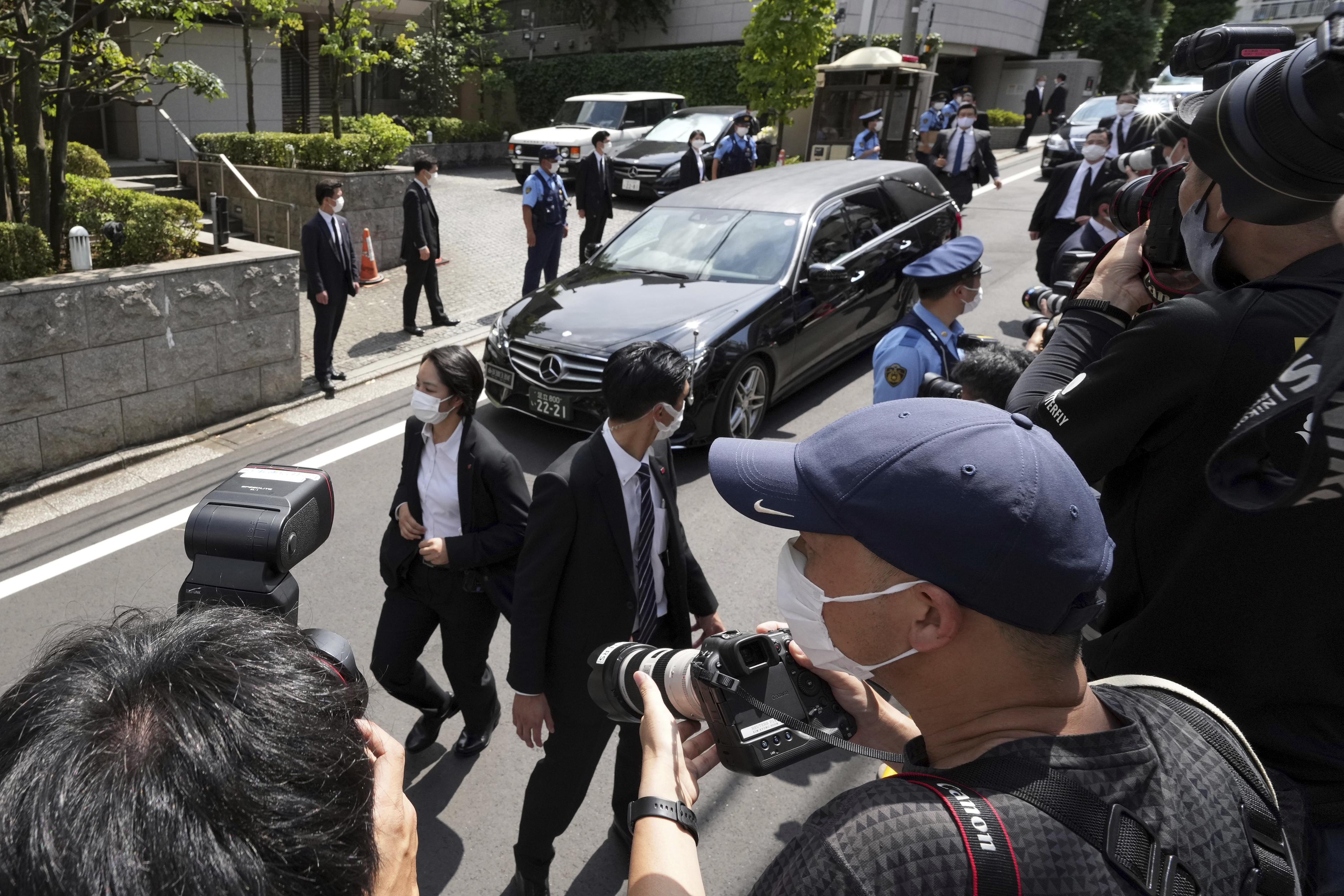 A car that is believed to carry the body of former Prime Minister Shinzo Abe arrives at his home Saturday.