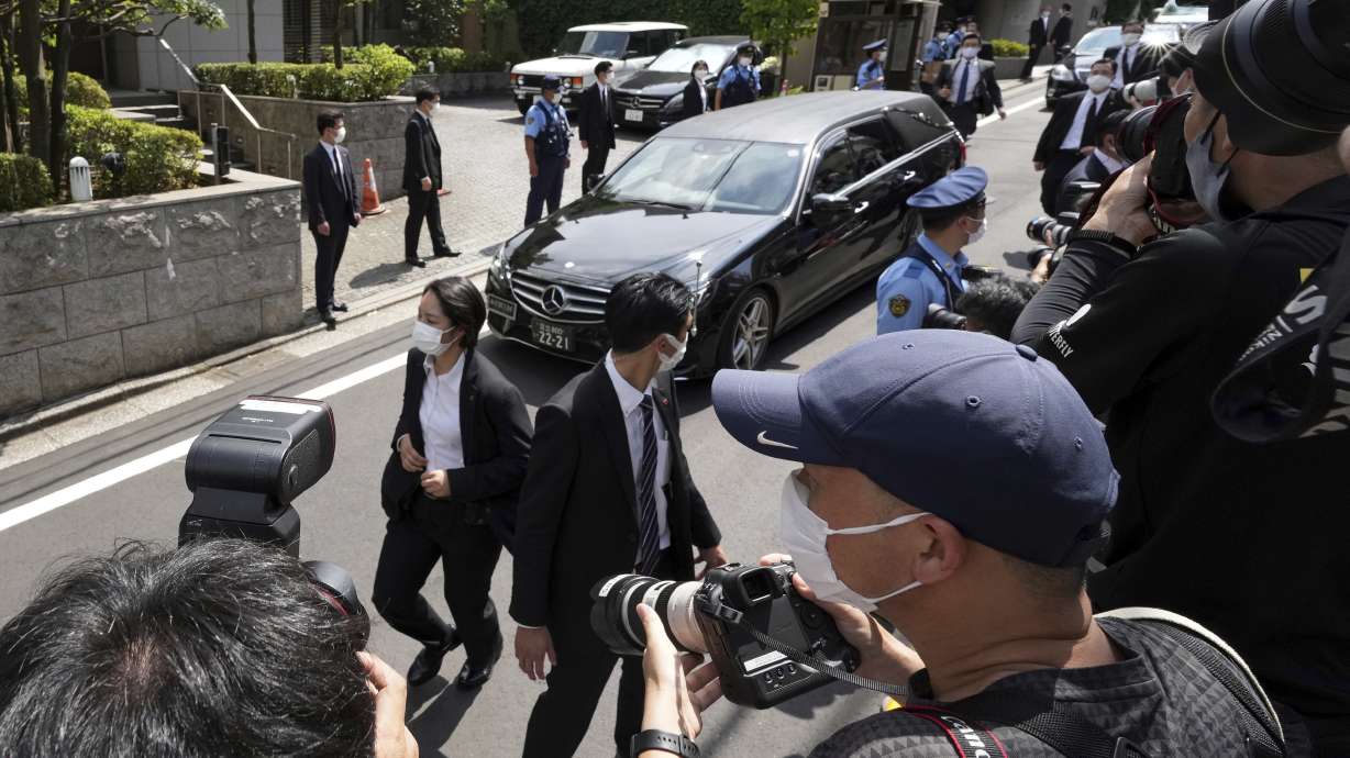 A car that is believed to carry the body of former Prime Minister Shinzo Abe arrives at his home Saturday.