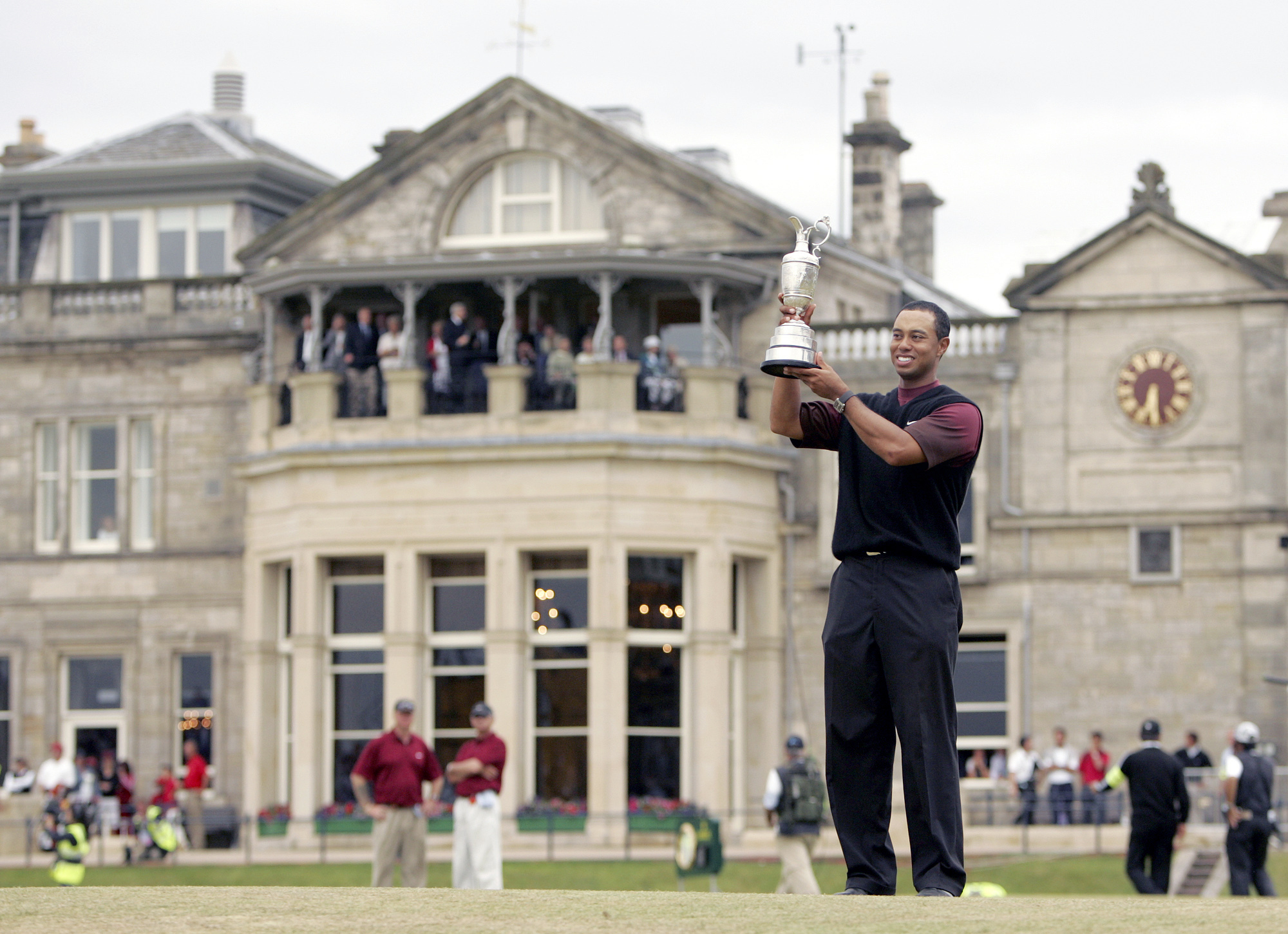 FILE - Tiger Woods holds the trophy as he stands in front of the clubhouse after winning the British Open golf championship on the Old Course at St. Andrews, Scotland, Sunday July 17, 2005. The Open Championship returns to the home of golf on July 14-17, 2022, to celebrate the 150th edition of the sport's oldest championship, which dates to 1860 and was first played at St. Andrews in 1873. 