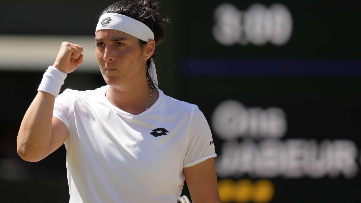 Tunisia's Ons Jabeur celebrates winning a point against Germany's Tatjana Maria in a women's singles semifinal match on day eleven of the Wimbledon tennis championships in London, Thursday, July 7, 2022.