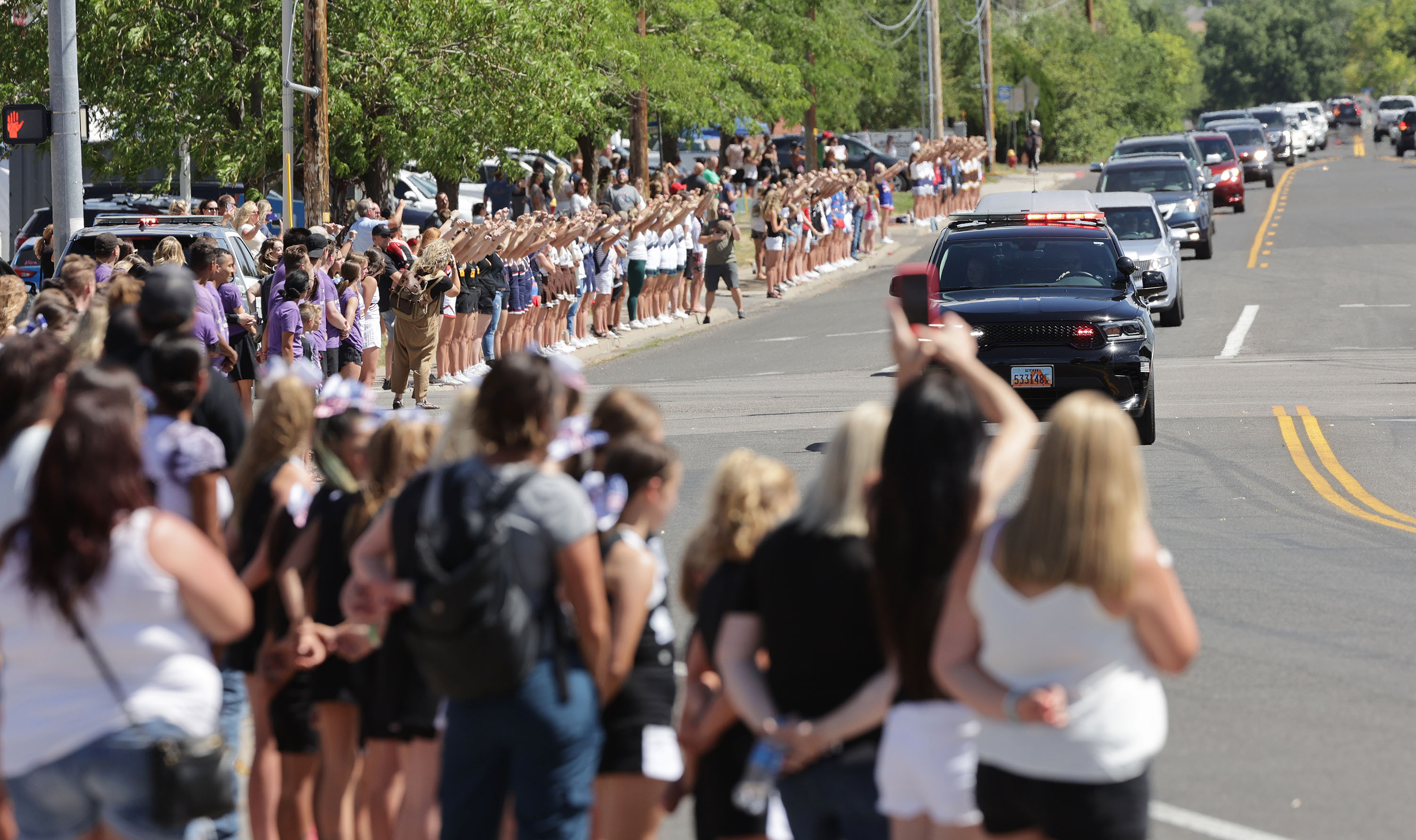 Cheerleaders line up to honor Macie Ann Hill during her funeral procession in Layton on Saturday. Hill was the young cheerleader that died from her injuries after her being run over during a parade.