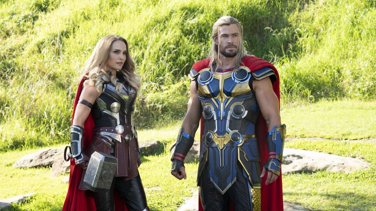 This image released by Marvel Studios shows Natalie Portman, left, and Chris Hemsworth in a scene from "Thor: Love and Thunder."