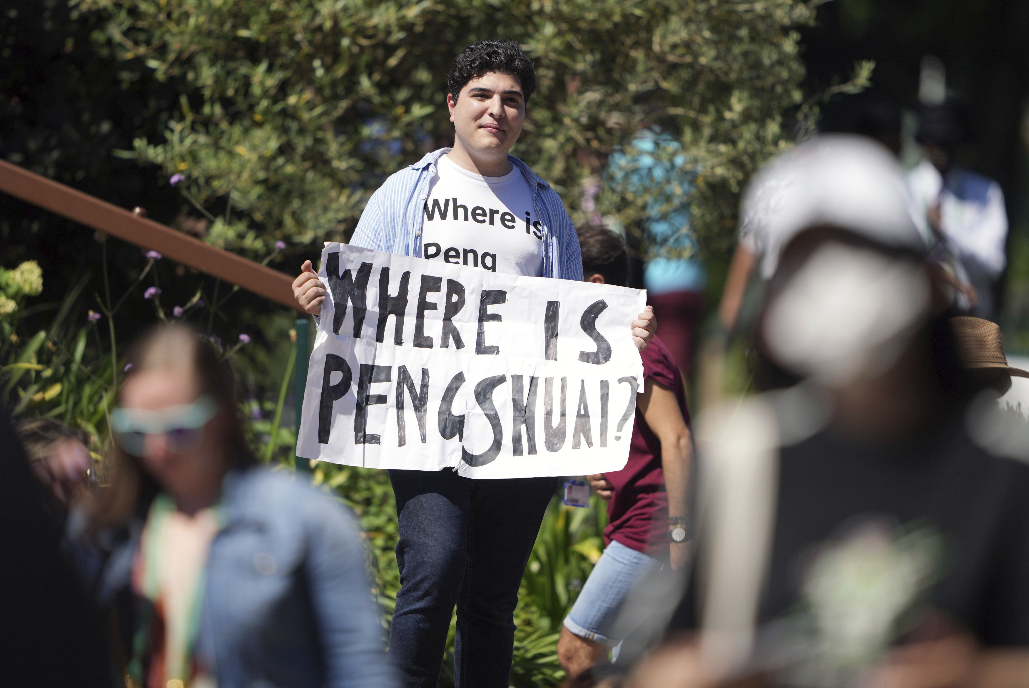 A protester holding a sign and wearing a t-shirt reading "where is Peng Shuai" on day twelve of the 2022 Wimbledon Championships at the All England Lawn Tennis and Croquet Club, Wimbledon, London, Friday July 8, 2022. Peng is a retired professional tennis player from China who last year accused a former high-ranking member of the country’s ruling Communist Party of sexual assault. She has made very few public appearances since then. 
