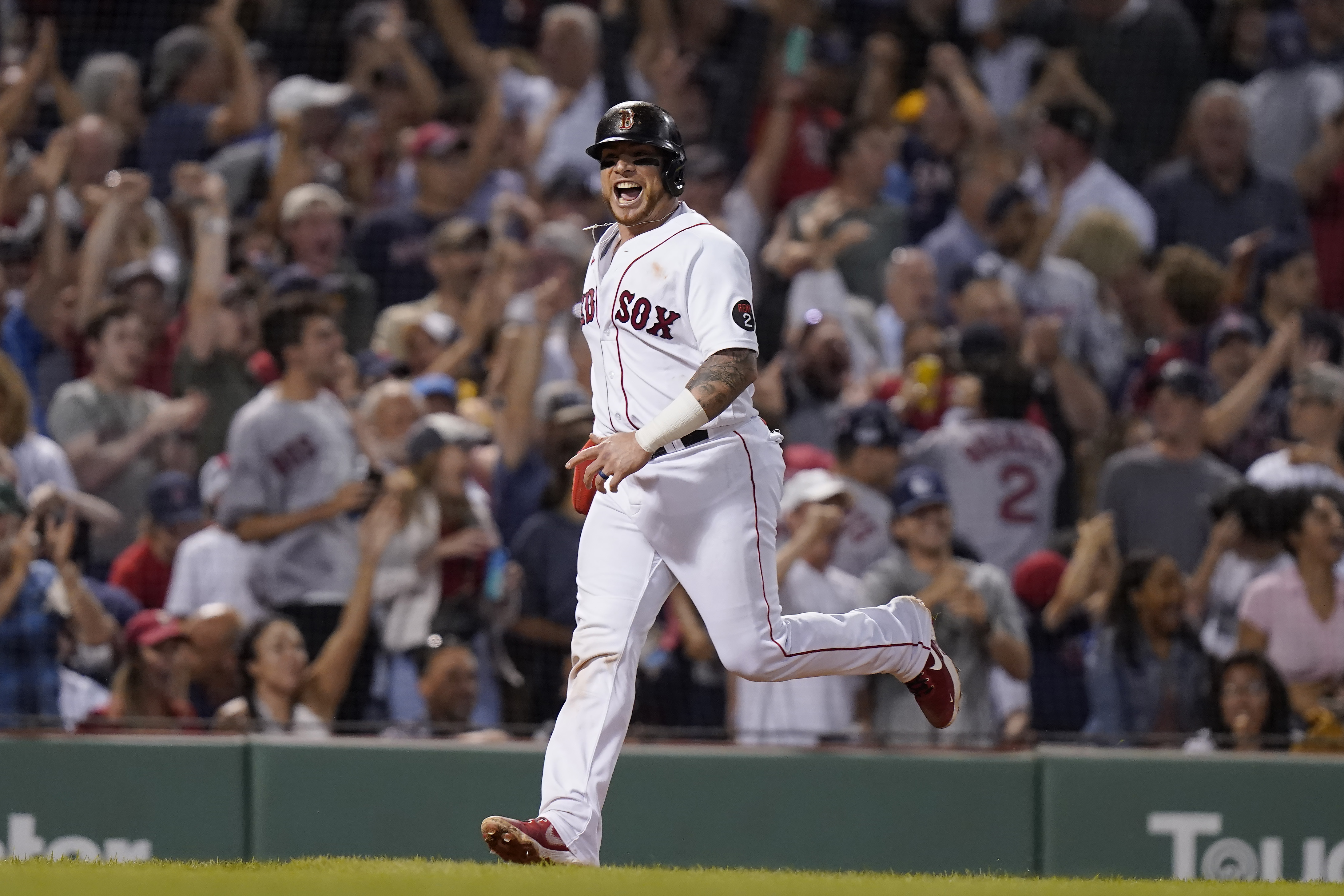 Boston Red Sox's Christian Vazquez celebrates as he arrives at home plate to score on a two-run home run hit by J.D. Martinez in the fifth inning of a baseball game against the New York Yankees, Sunday, July 10, 2022, in Boston. 