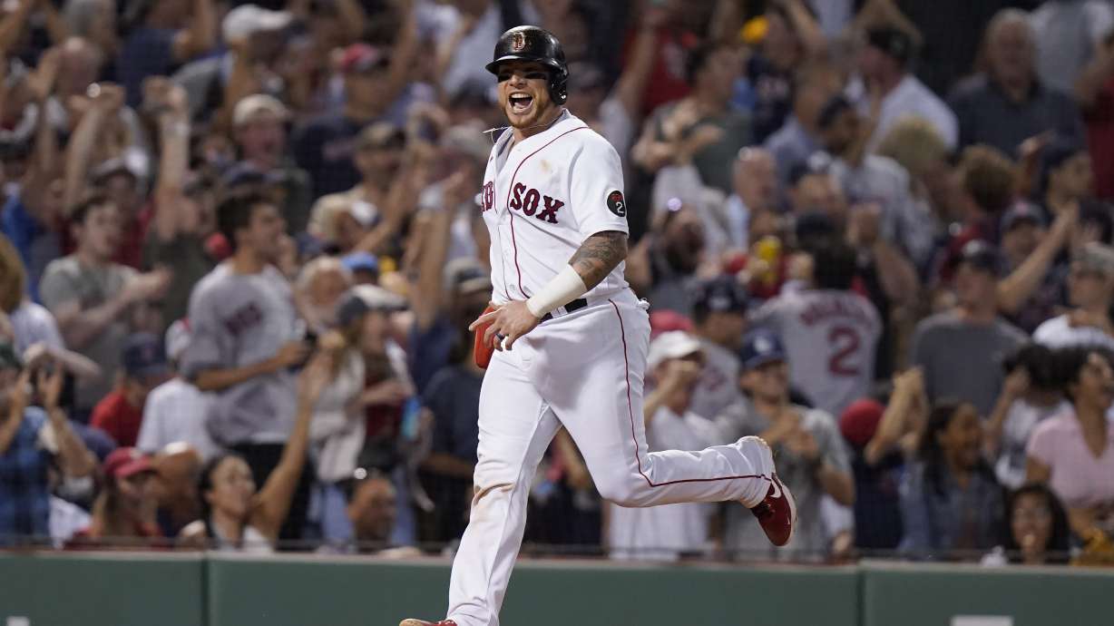 Boston Red Sox's Christian Vazquez celebrates as he arrives at home plate to score on a two-run home run hit by J.D. Martinez in the fifth inning of a baseball game against the New York Yankees, Sunday, July 10, 2022, in Boston.