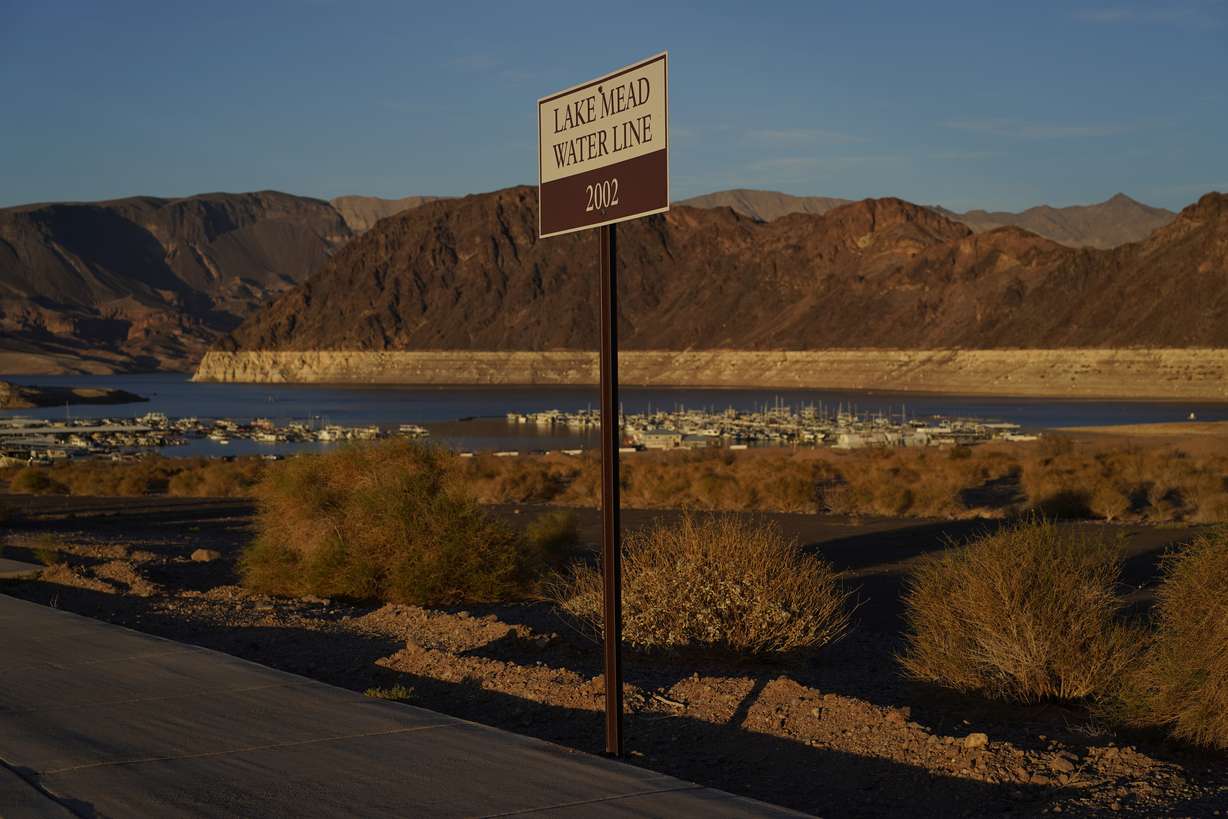 A sign marks the water line from 2002 near Lake Mead at the Lake Mead National Recreation Area, Saturday, near Boulder City, Nev. The largest U.S. reservoir has shrunken to a record low amid a punishing drought and the demands of 40 million people in seven states who are sucking the Colorado River dry.