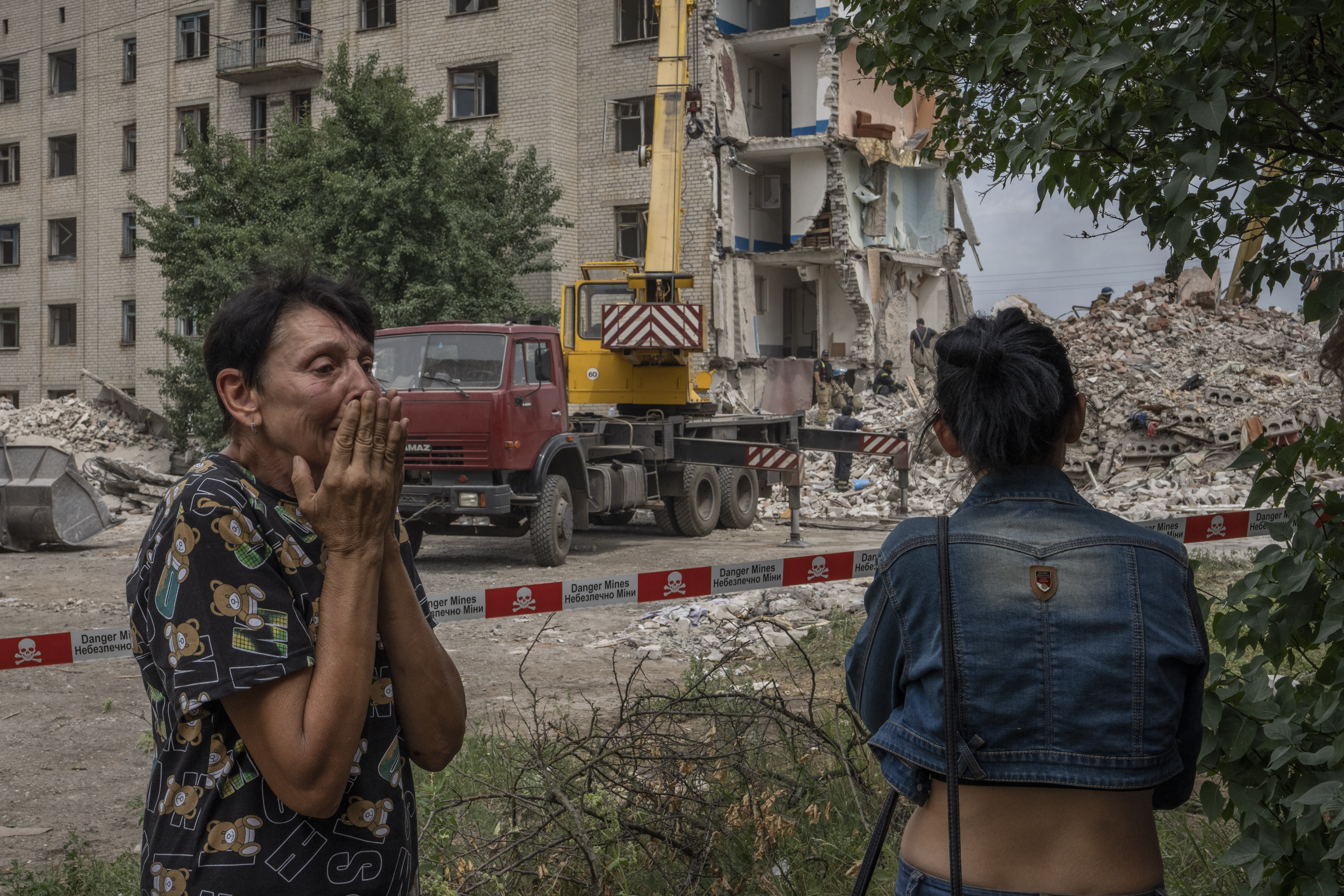 Iryna Shulimova, 59, weeps at the scene in the aftermath of a Russian rocket that hit an apartment residential block, in Chasiv Yar, Donetsk region, eastern Ukraine on Sunday. At least 15 people were killed and more than 20 people may still be trapped in the rubble, officials said Sunday. 