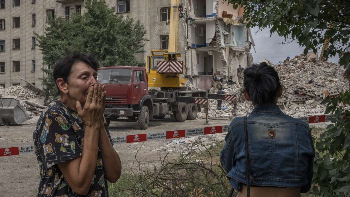 Iryna Shulimova, 59, weeps at the scene in the aftermath of a Russian rocket that hit an apartment residential block, in Chasiv Yar, Donetsk region, eastern Ukraine on Sunday. At least 15 people were killed and more than 20 people may still be trapped in the rubble, officials said Sunday.