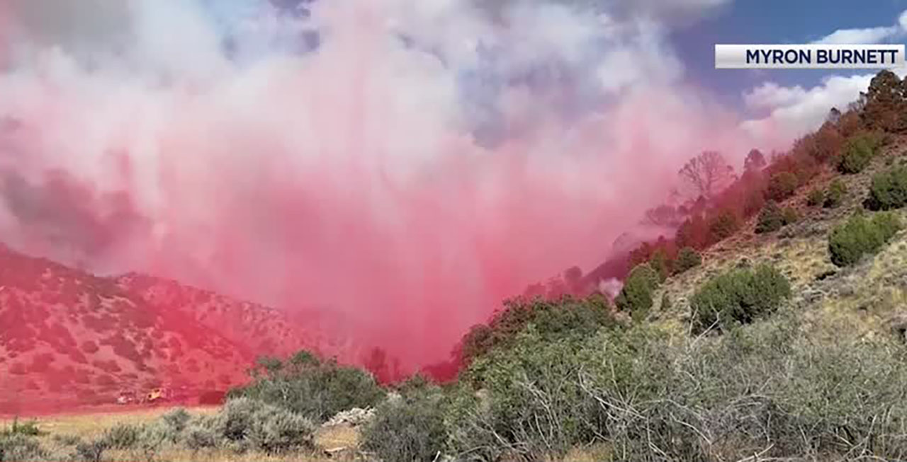 Fire crews drop retardant on the scene of a wildfire in Tooele County.
