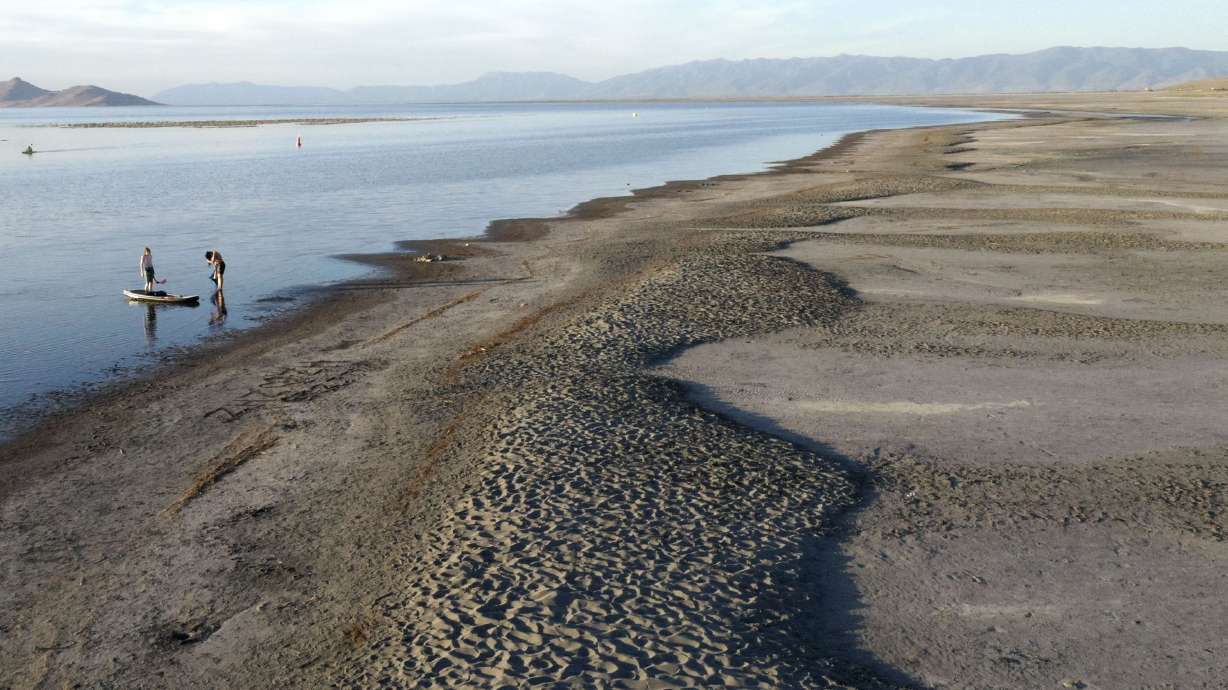 Paddle boarders leave the water at the Great Salt Lake State Park in Salt Lake City on Friday, June 10. The lake dropped to its lowest level on record last week after one of Utah's driest first halves to a year.
