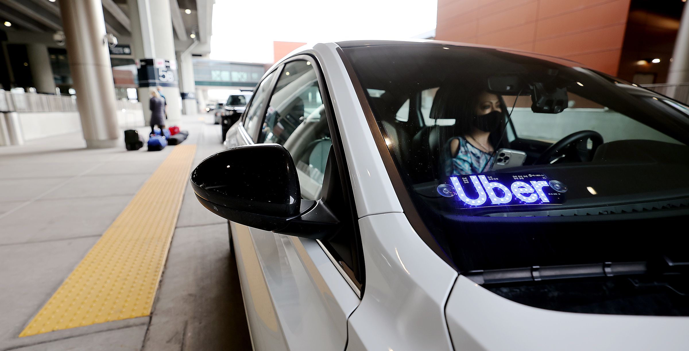 Uber driver Teresea Melendez waits for her passenger at the Salt Lake City Airport on Feb. 1, 2021. Confidential documents leaked to a news organization claim to show how the rideshare company “flouted laws, duped police, exploited violence against drivers and secretly lobbied governments during its aggressive global expansion.”