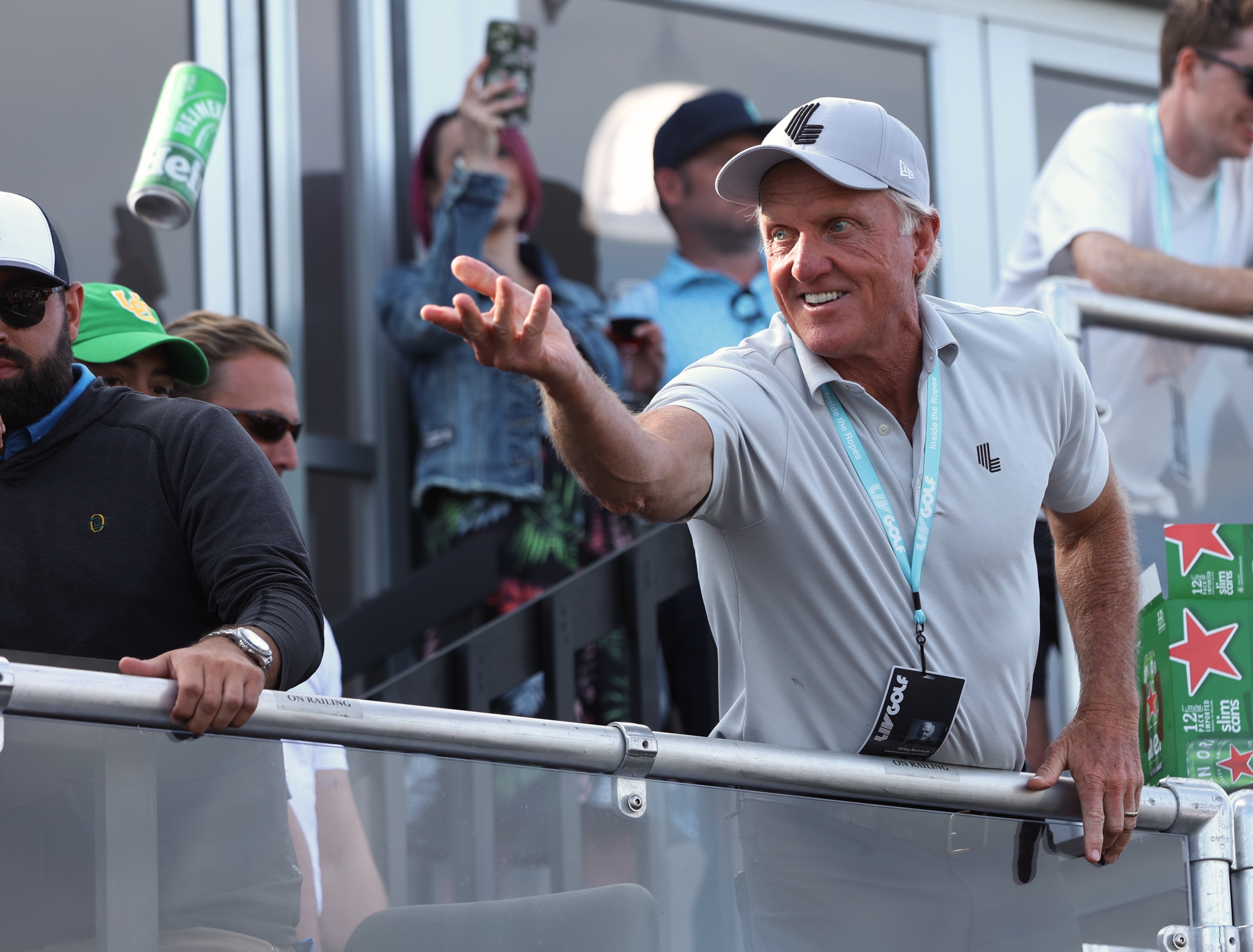 Greg Norman, CEO of LIV Golf, tosses a beer to spectators into the crowd surrounding the 18th green at the Portland Invitational LIV Golf tournament in North Plains, Ore., Saturday, July 2, 2022. 