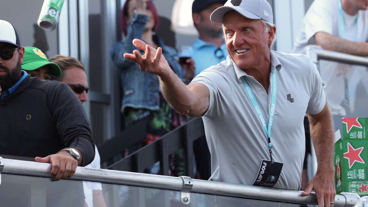 Greg Norman, CEO of LIV Golf, tosses a beer to spectators into the crowd surrounding the 18th green at the Portland Invitational LIV Golf tournament in North Plains, Ore., Saturday, July 2, 2022.