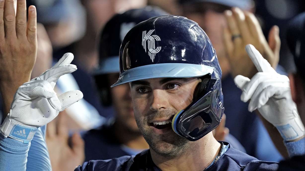 Kansas City Royals' Whit Merrifield celebrates in the dugout after hitting a two-run home run during the eighth inning of a baseball game against the Cleveland Guardians Friday, July 8, 2022, in Kansas City, Mo.