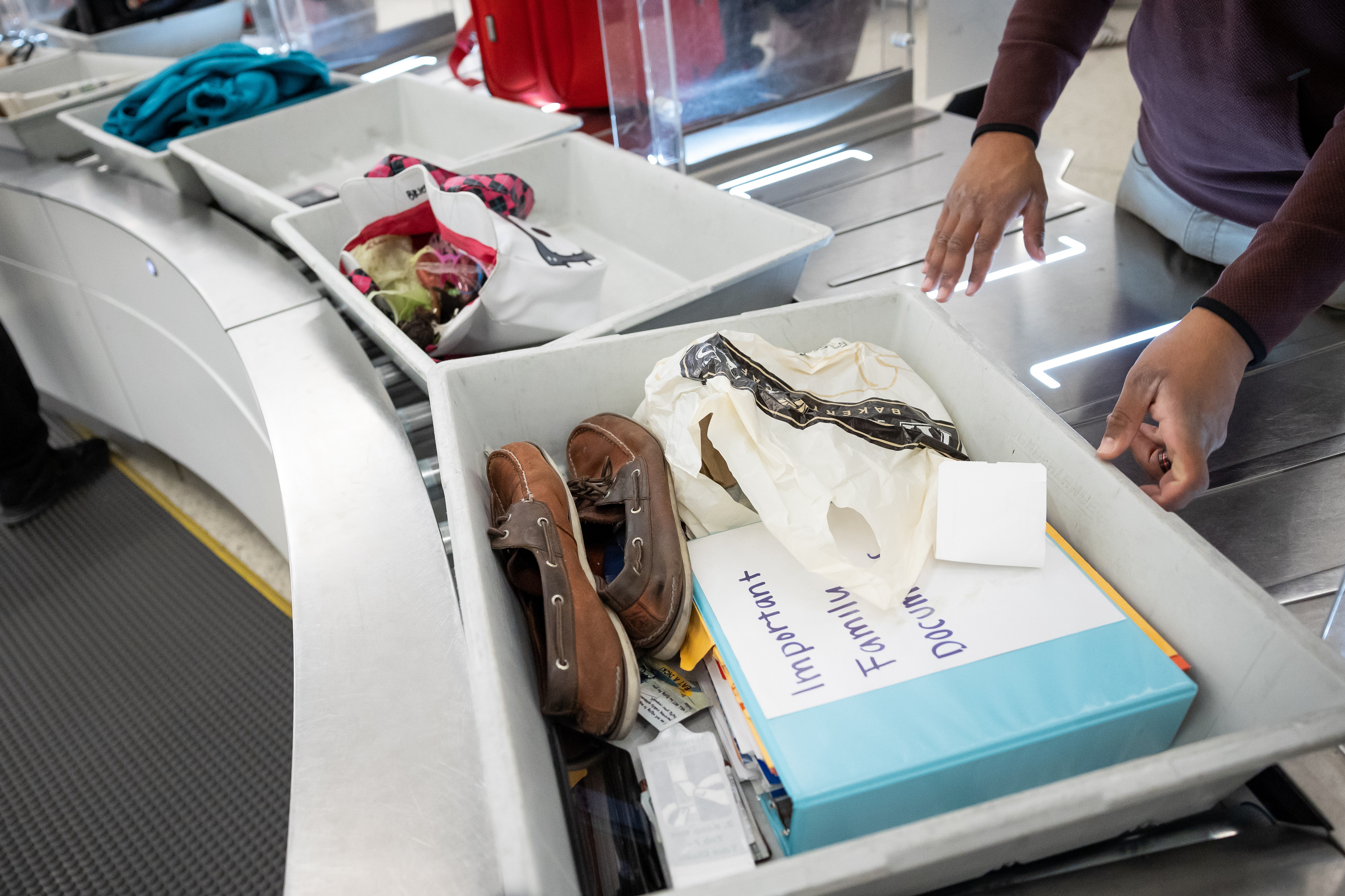 Travelers move through the security checkpoint at Salt Lake City International Airport in Salt Lake City on Nov. 18, 2021. An argument between two men standing in line to go through TSA screening at the airport escalated to a potential felony crime on Monday, according to police.