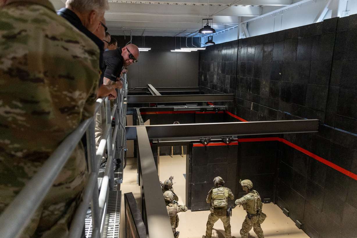 Spectators watch soldiers from the Utah National Guard's 19th Special Forces Group (Airborne) perform a demonstration of advanced urban combat in a new Special Operations Forces Live-Fire Shoot House at Camp Williams on Monday.