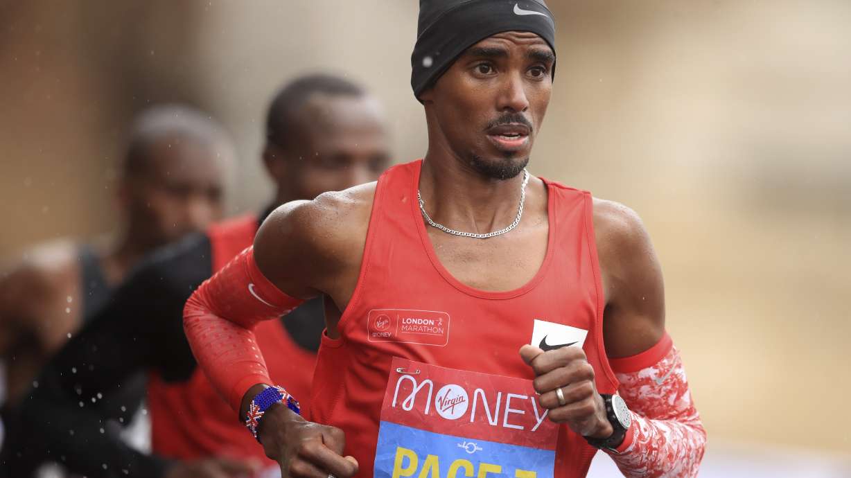 FILE - Britain's Mo Farah, right, runs as a pacemaker during the London Marathon in London, England, Oct. 4, 2020. Four-time Olympic champion Farah has disclosed he was brought into Britain illegally from Djibouti under the name of another child. “The truth is I’m not who you think I am," the 39-year-old Farah told the BBC in a documentary called “The Real Mo Farah.”
